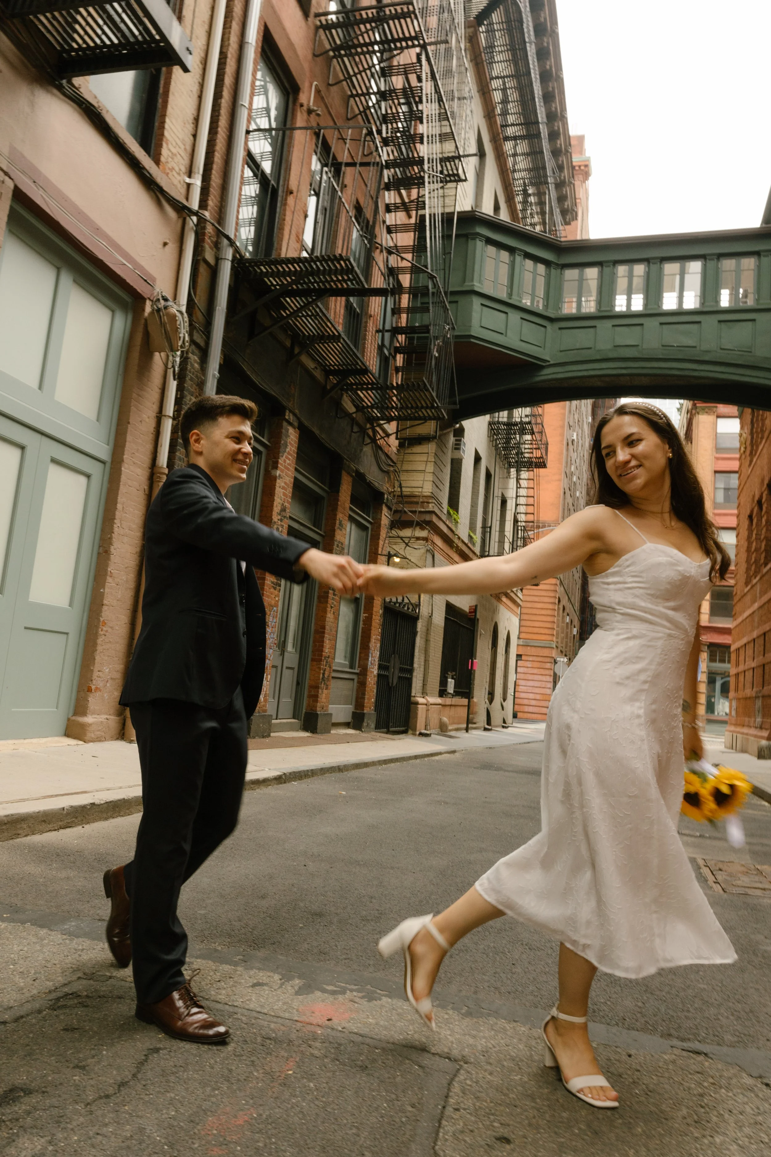 Couple dancing together on a quiet New York City street after eloping