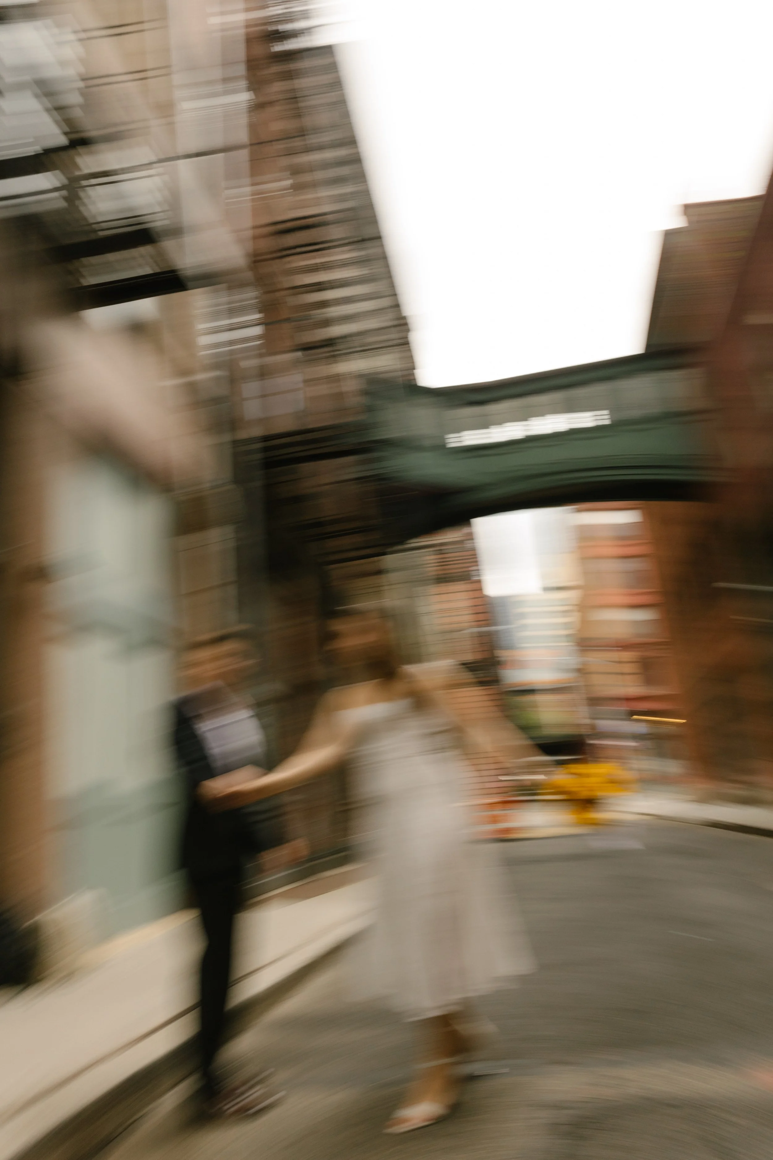 Motion-blur portrait beneath Staple Street Skybridge during a New York courthouse wedding