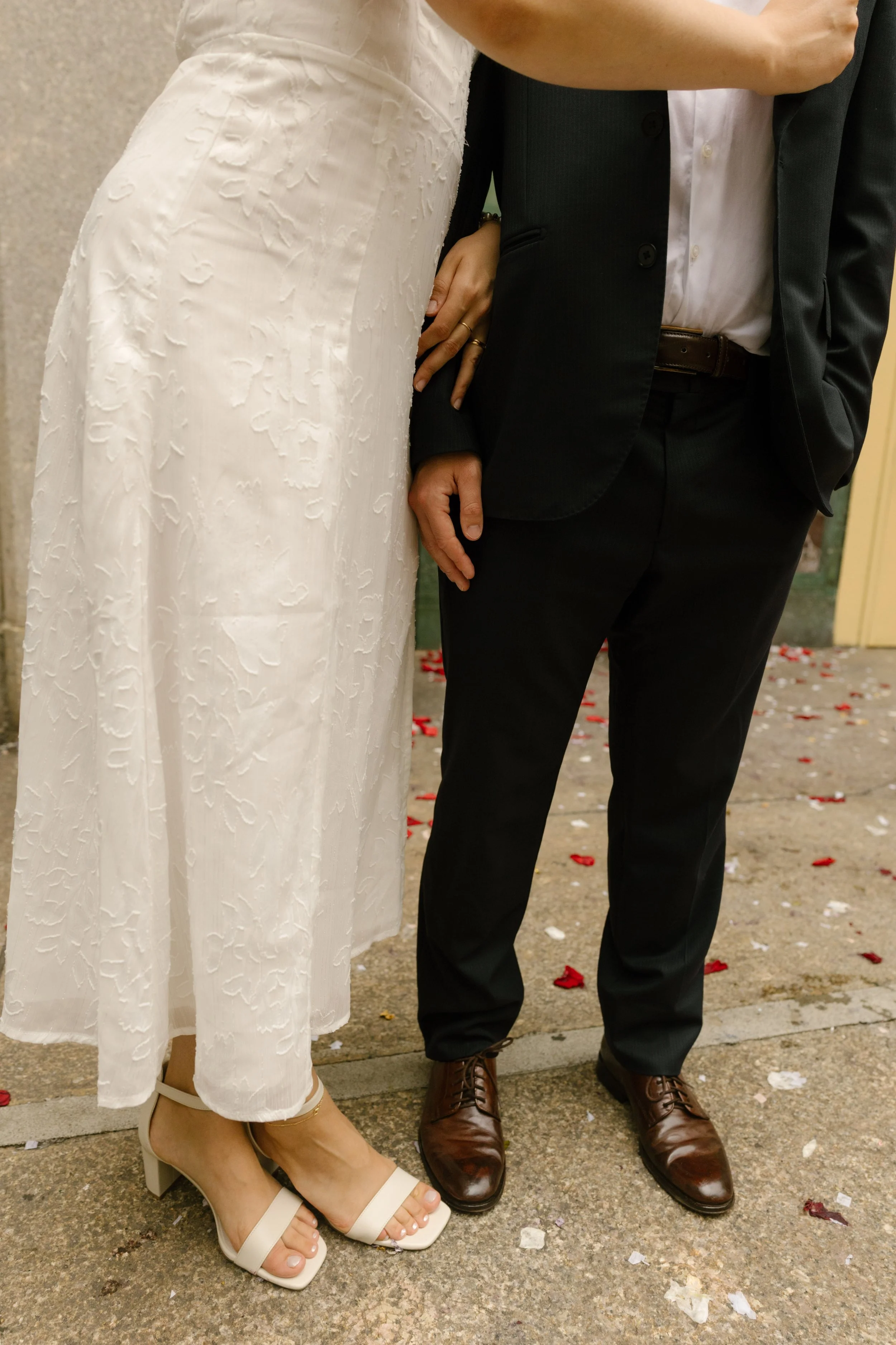Close-up details from a New York courthouse wedding with confetti-covered sidewalks and modern wedding attire in Manhattan