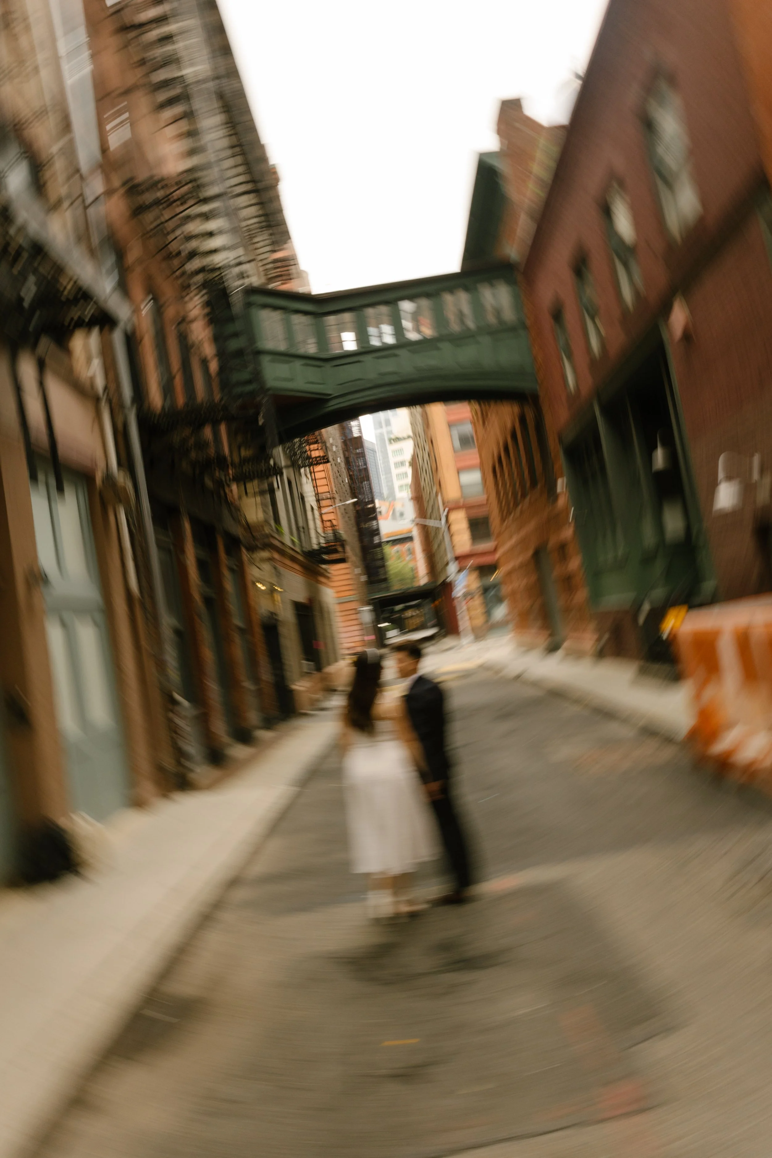 Motion blur photo of couple beneath Staple Street Skybridge after their New York courthouse wedding in Tribeca