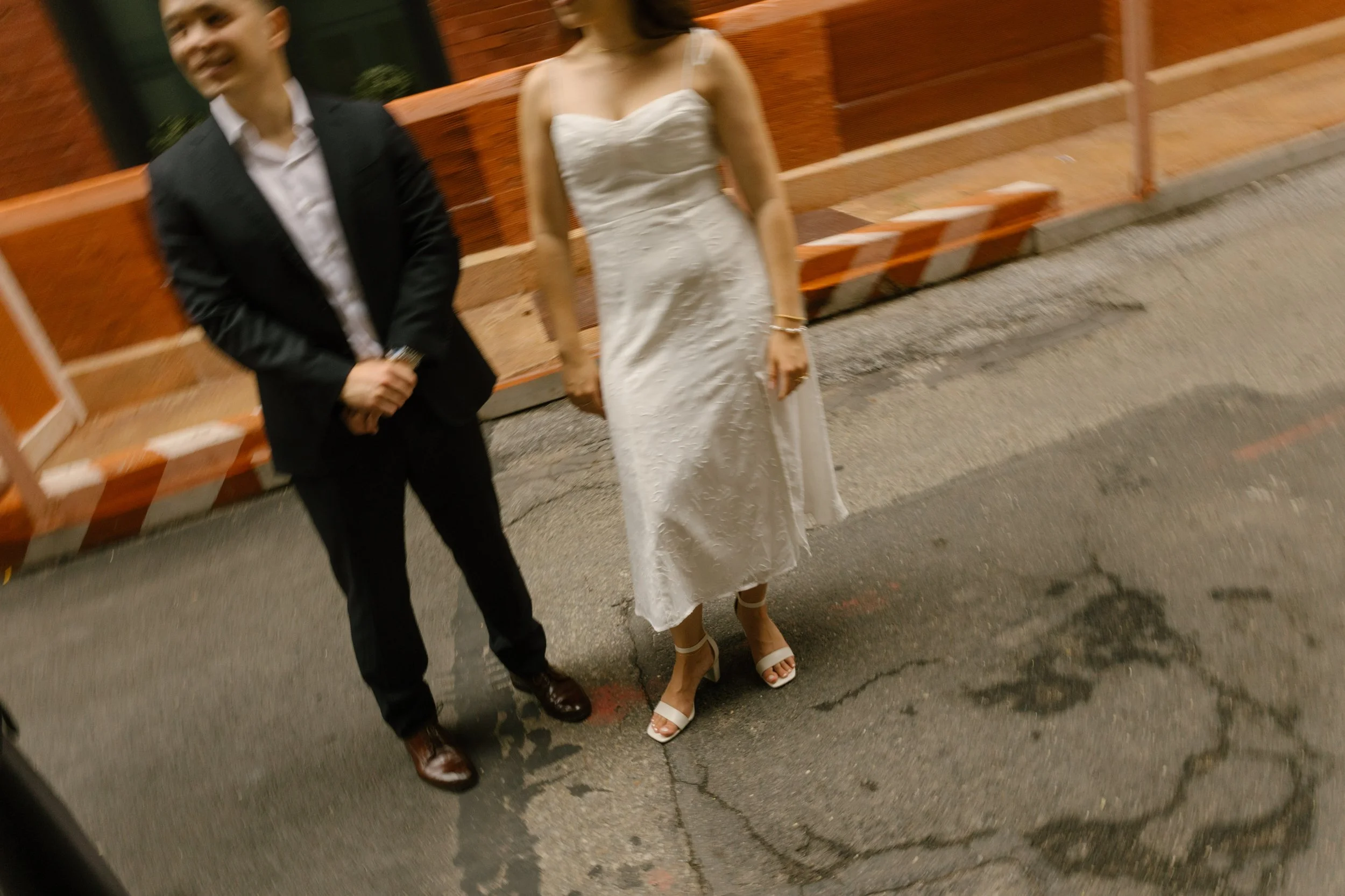 Candid blurry film-inspired photo of couple wandering through NYC after courthouse wedding ceremony