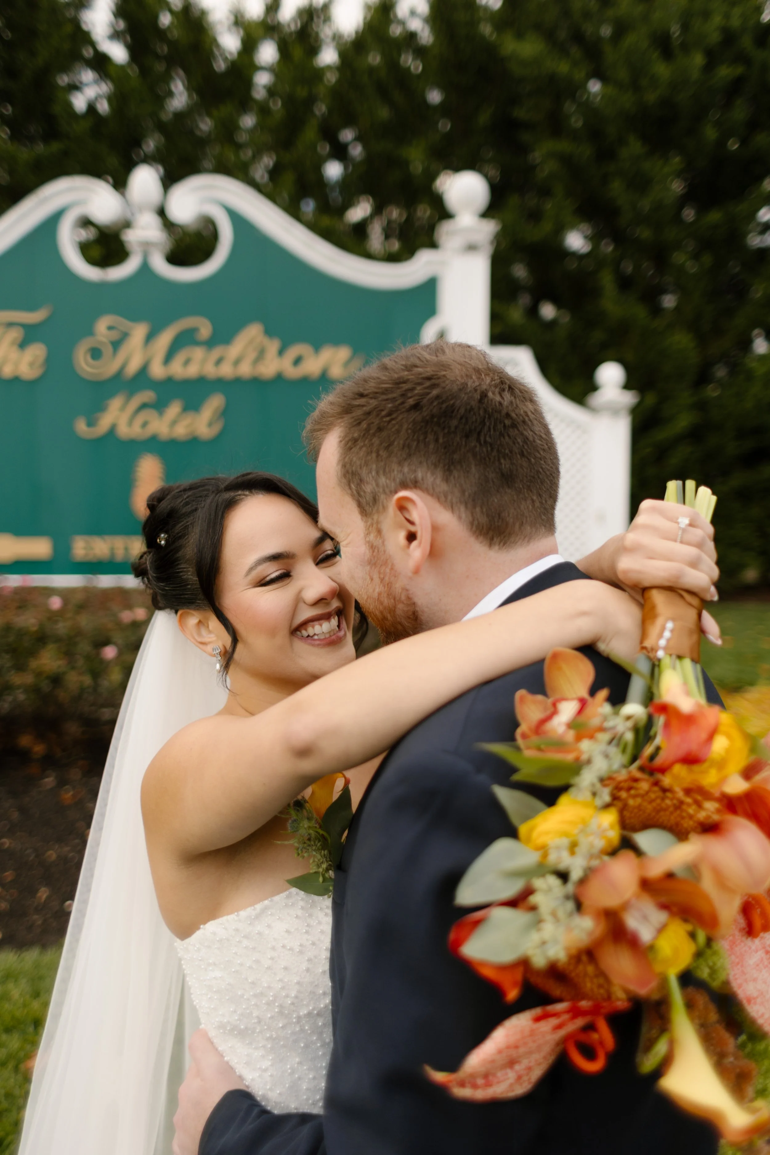 Newlyweds embracing outside The Madison Hotel during a classic wedding in New York portrait session
