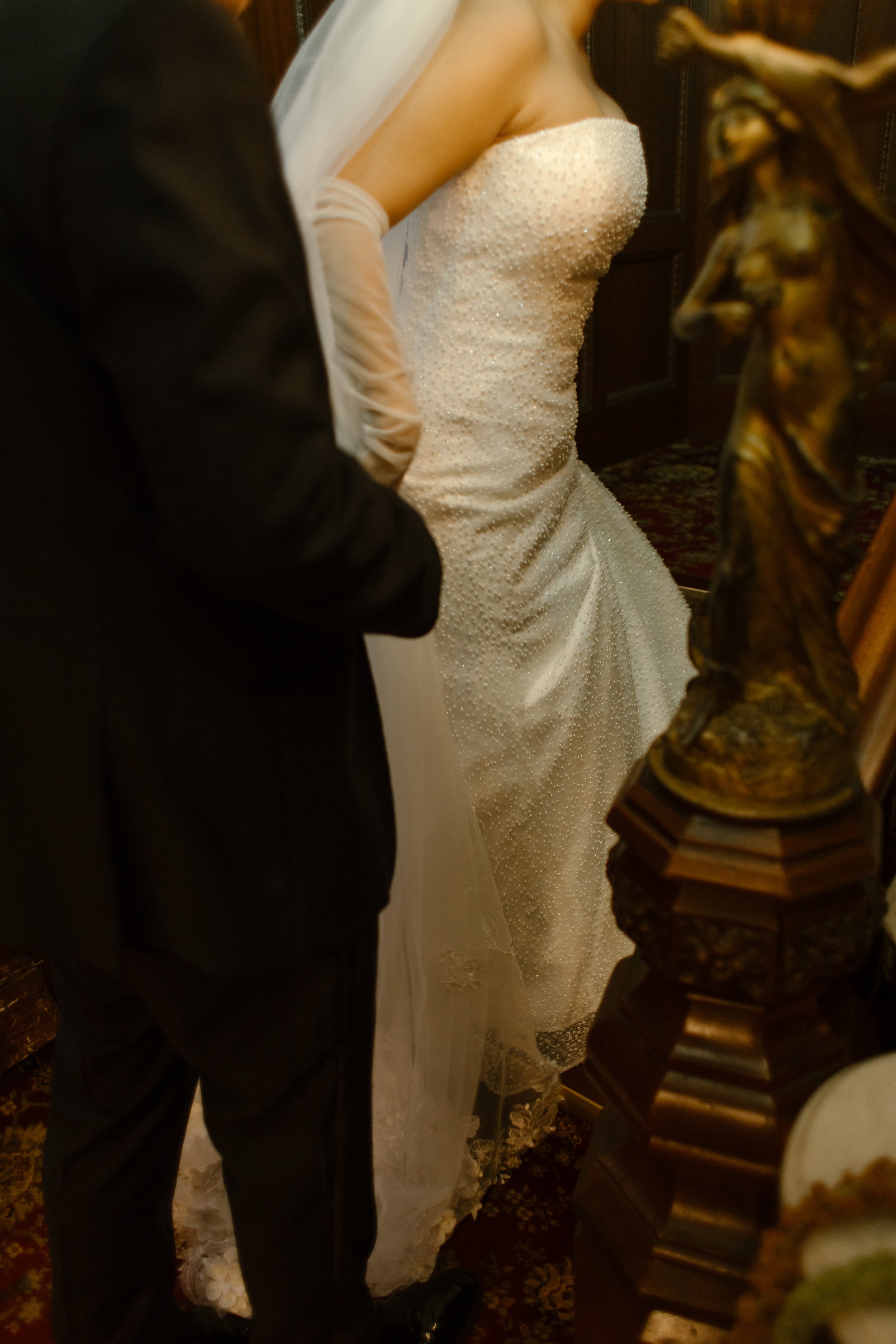 Bride and groom sharing a quiet moment inside a historic mansion staircase before the ceremony