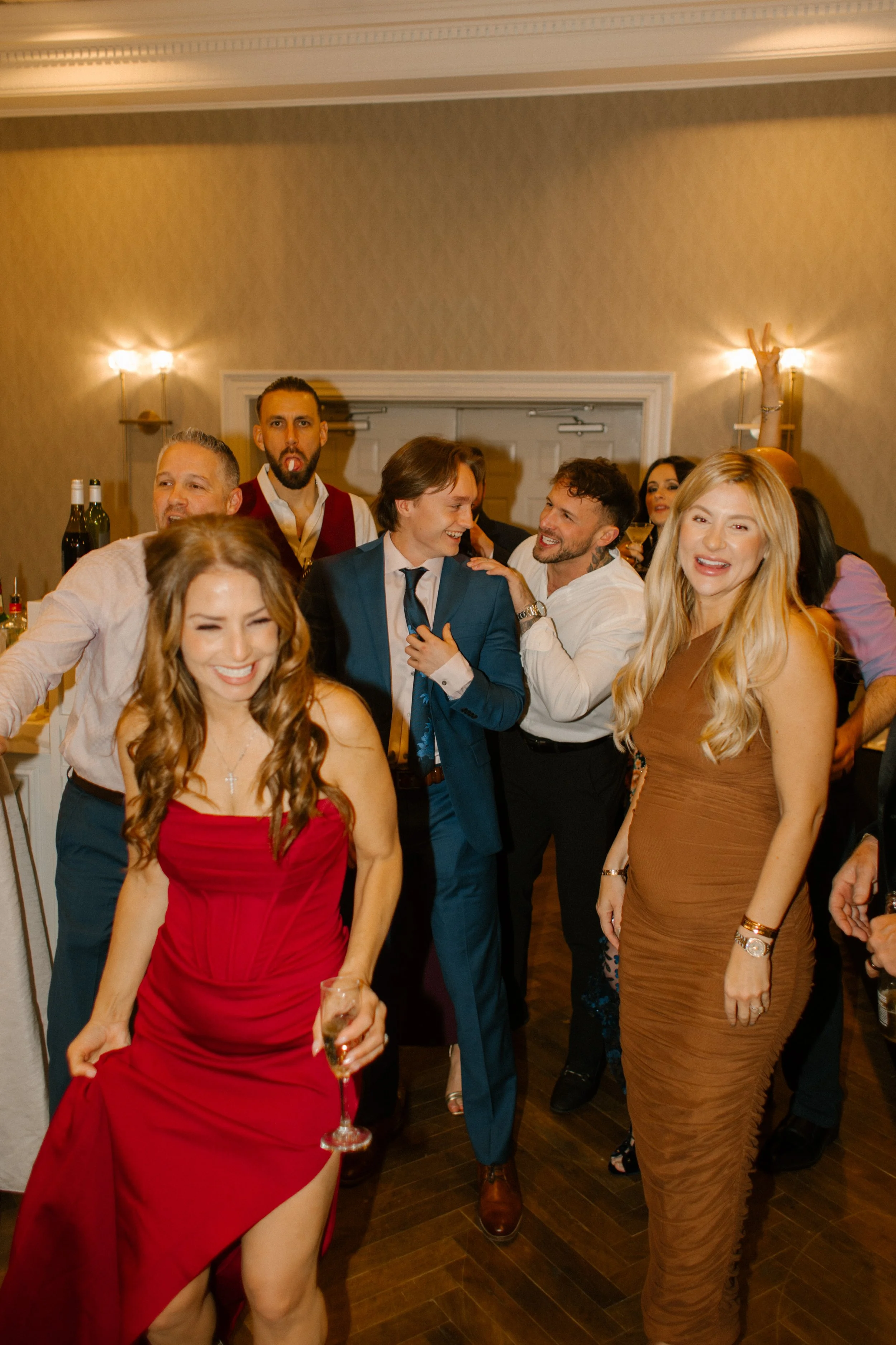 Friends and family dancing and enjoying the reception festivities at a wedding in New York venue