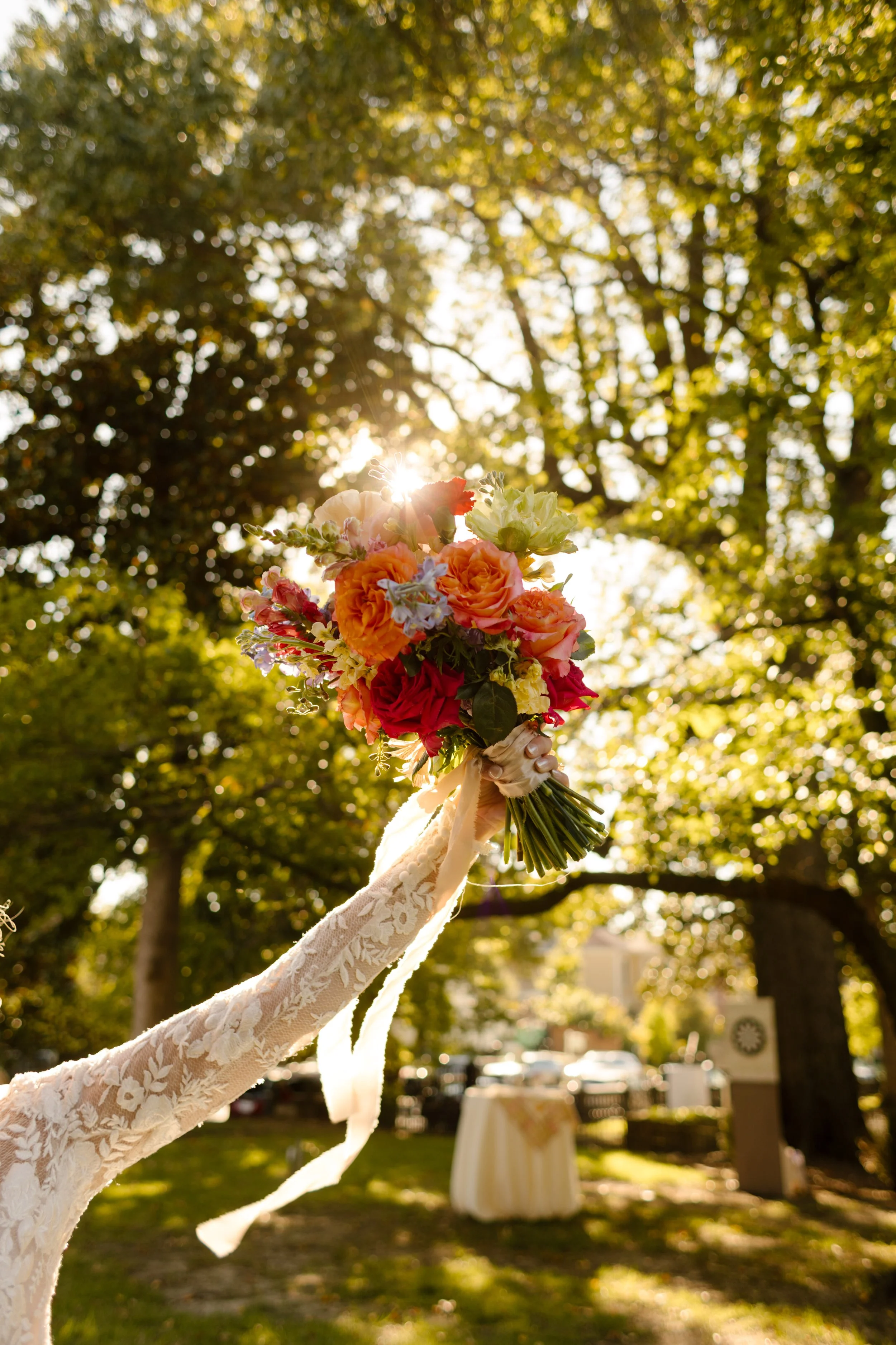 Colorful bridal bouquet raised in sunlight, highlighting bold 2027 wedding trends