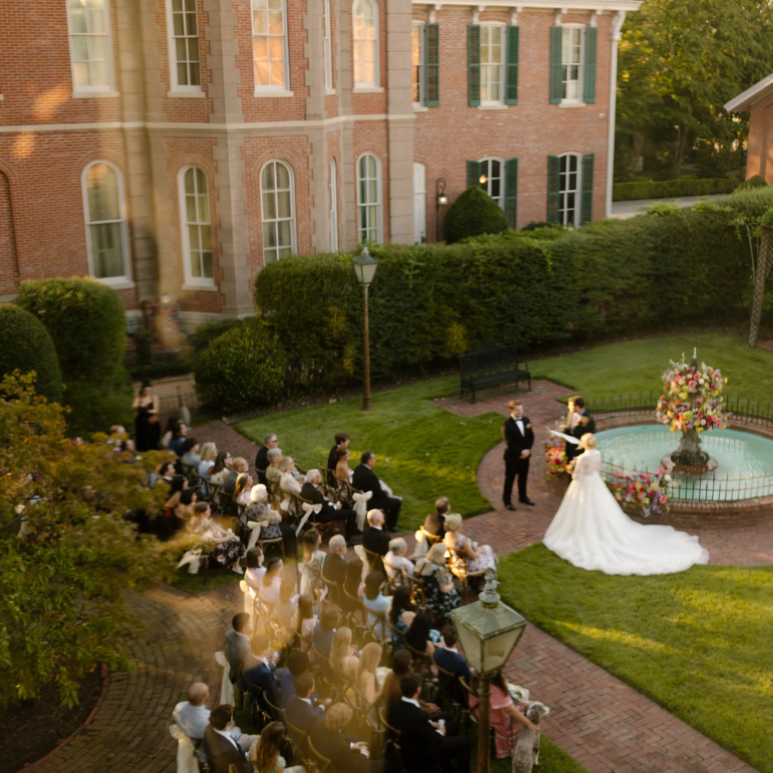 Outdoor wedding ceremony overlooking a historic estate and fountain garden