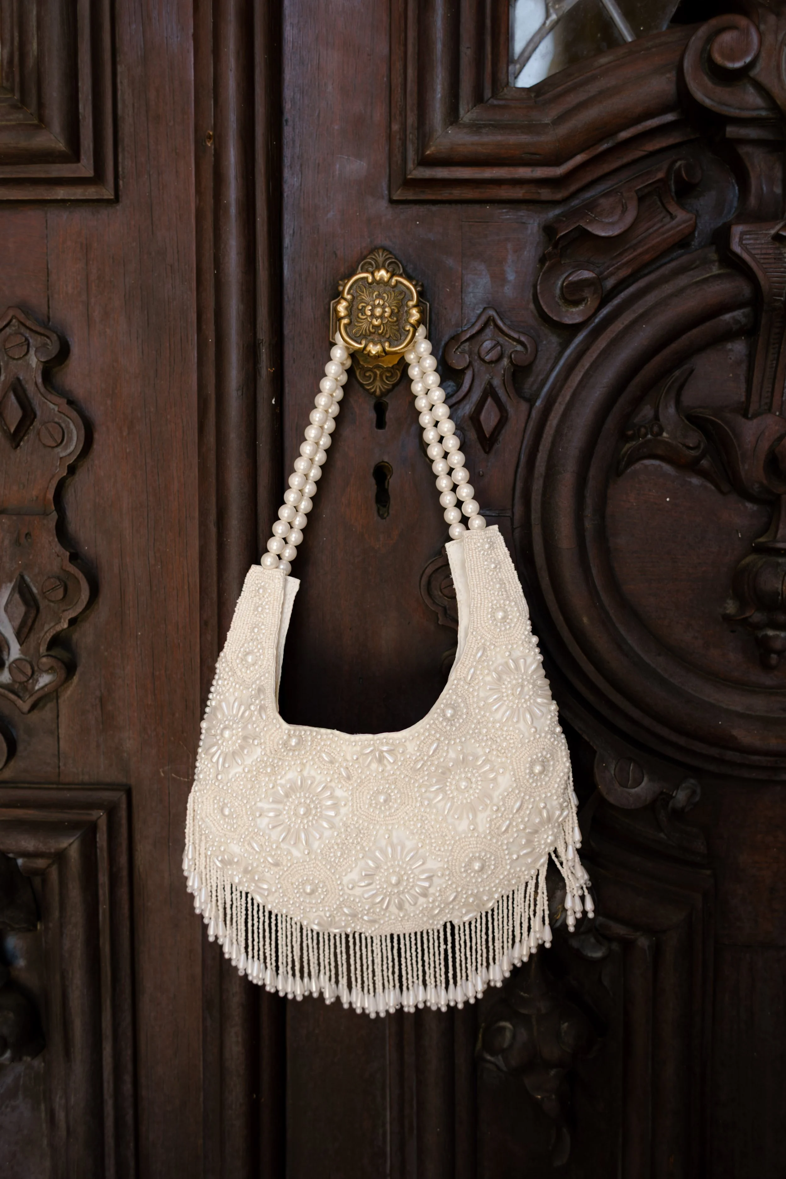 Pearl-beaded bridal handbag featuring statement accessories popular in 2027 wedding trends