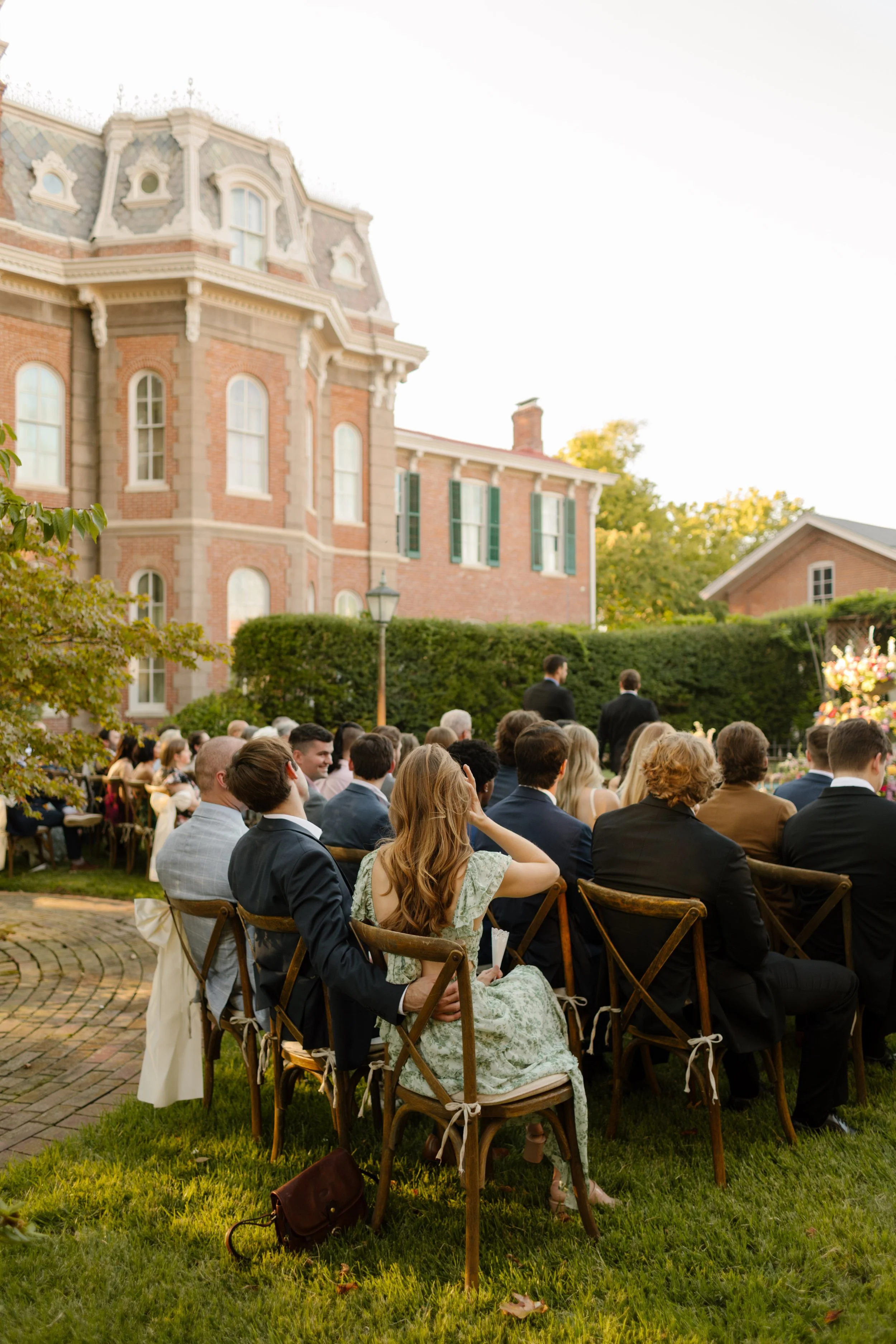 Guests seated for an outdoor garden ceremony at a historic estate, embracing intimate 2027 wedding trends