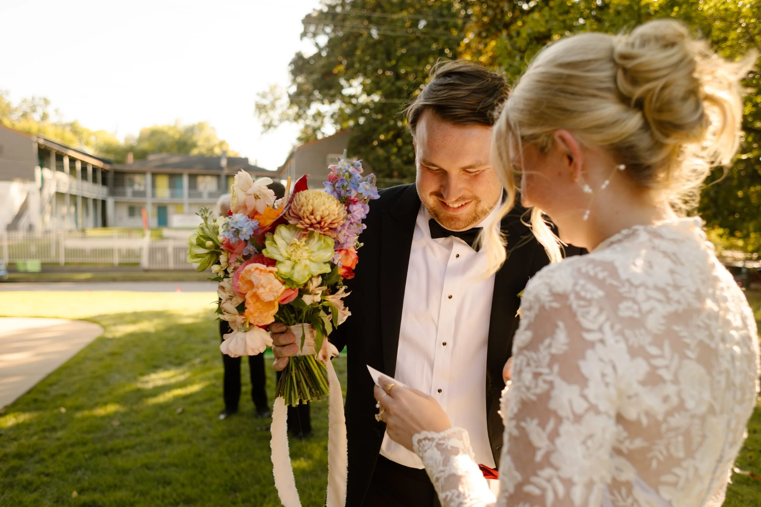 Couple reading a personal note together outdoors, highlighting meaningful 2027 wedding trends centered on guest experiences