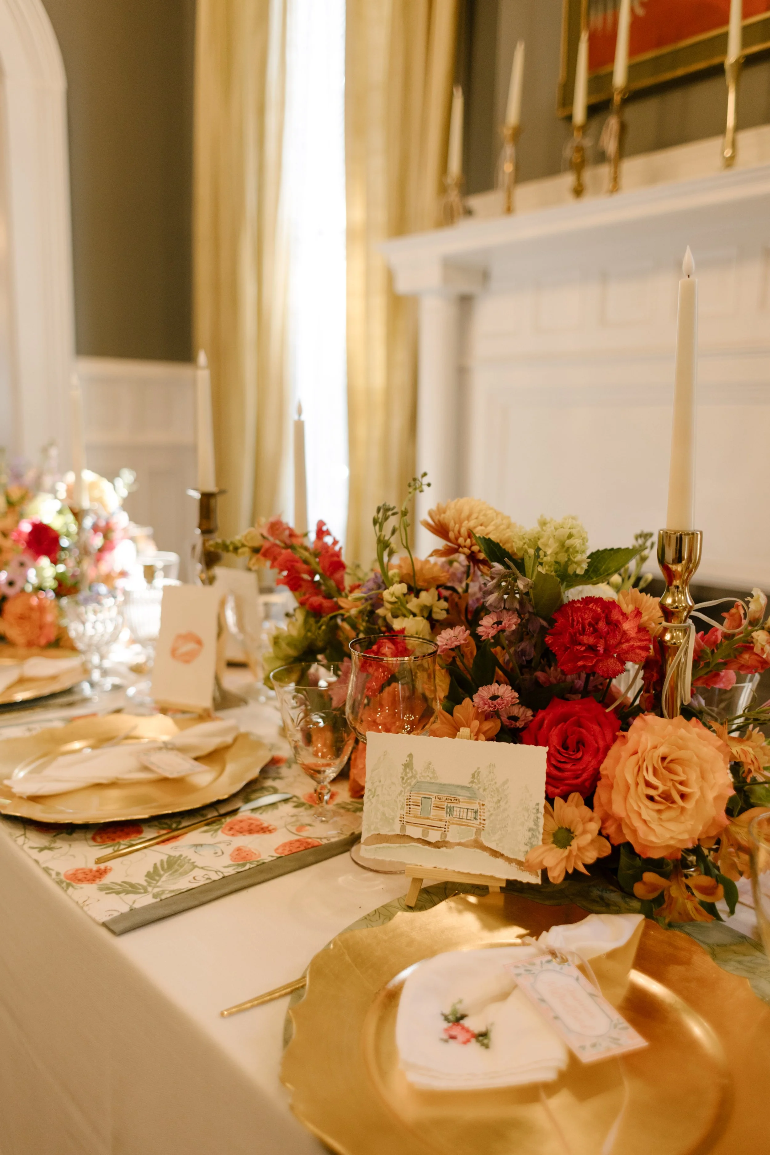 Reception table styled with layered florals, custom artwork place cards, and candlelight inspired by 2027 wedding trends