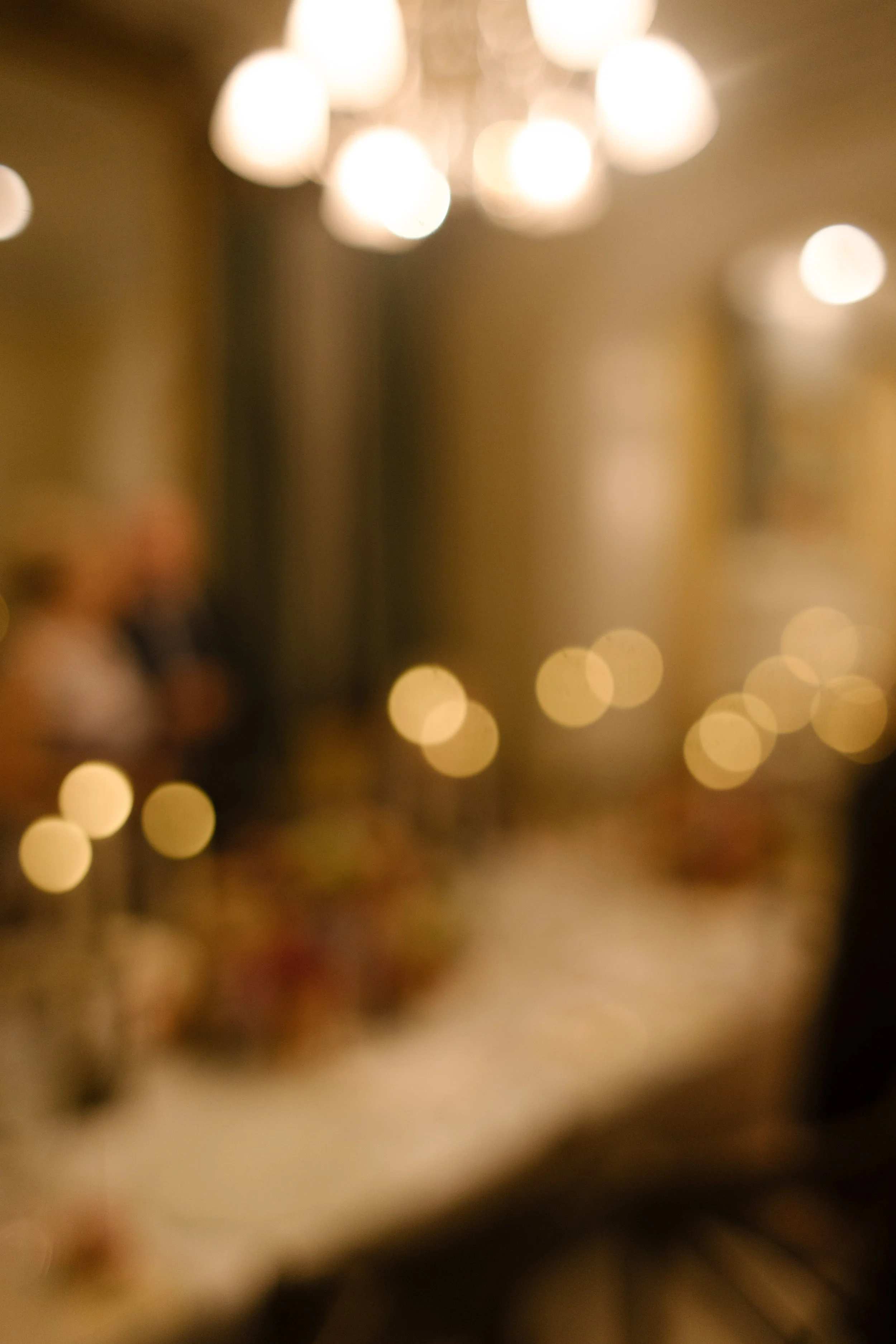 Soft candlelight and dreamy bokeh creating an intimate atmosphere during an elegant wedding reception