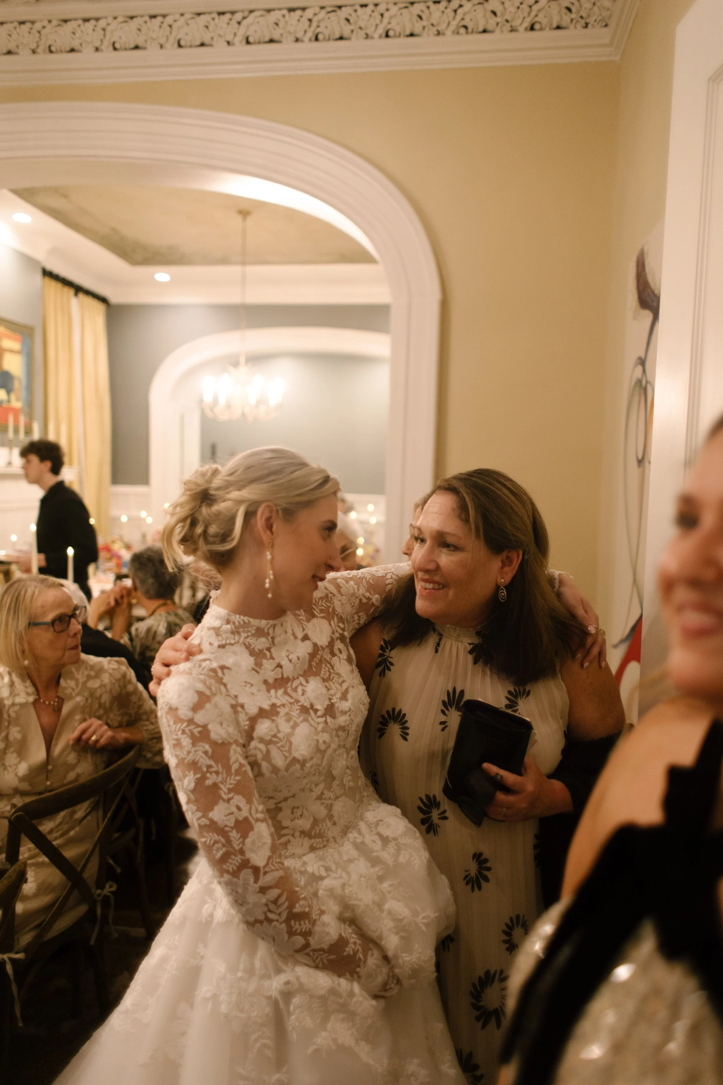 The bride sharing a heartfelt conversation with a loved one during an intimate and elegant wedding reception