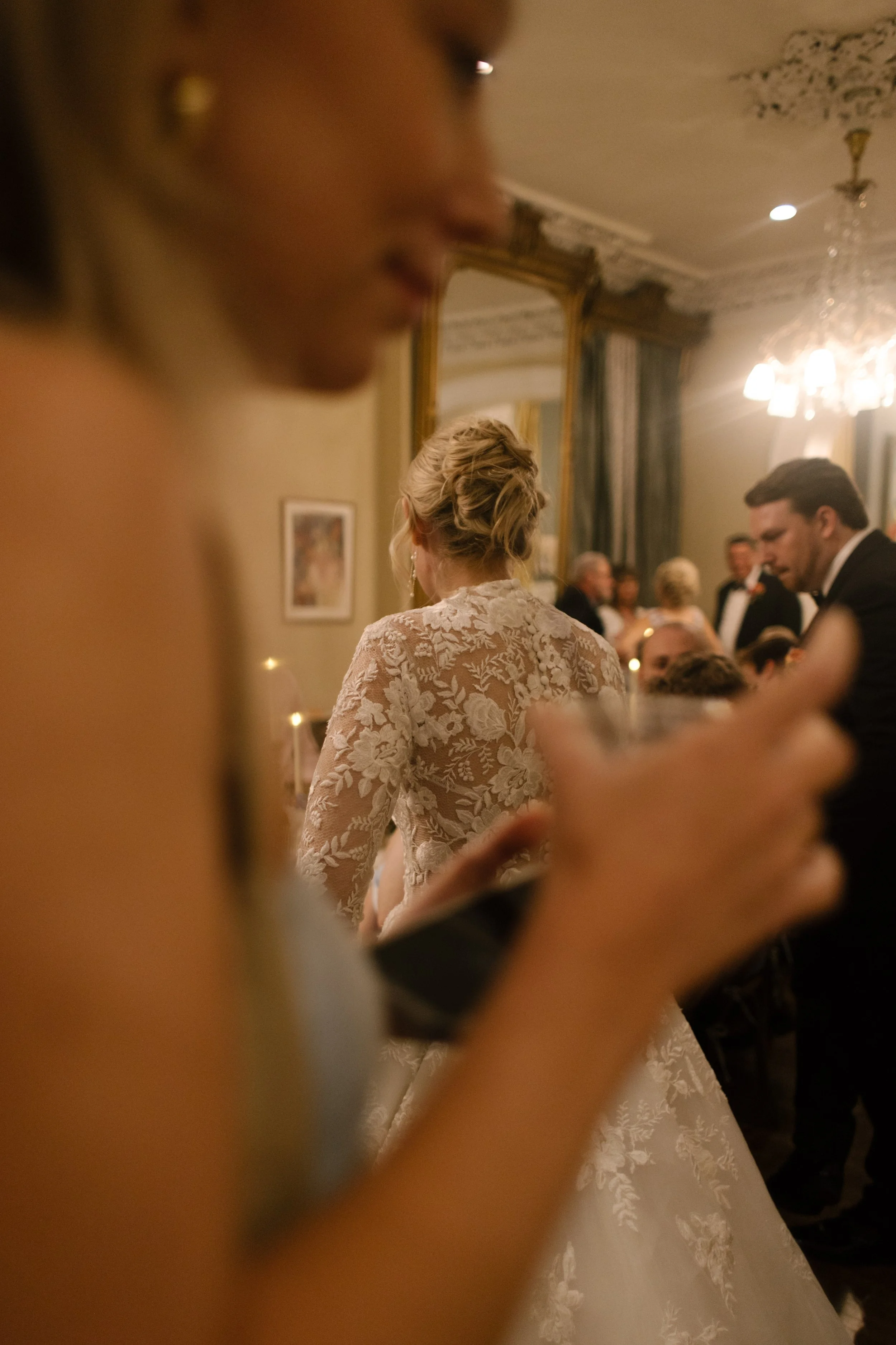 Guests enjoying the evening festivities while the bride mingles throughout her candlelit wedding reception