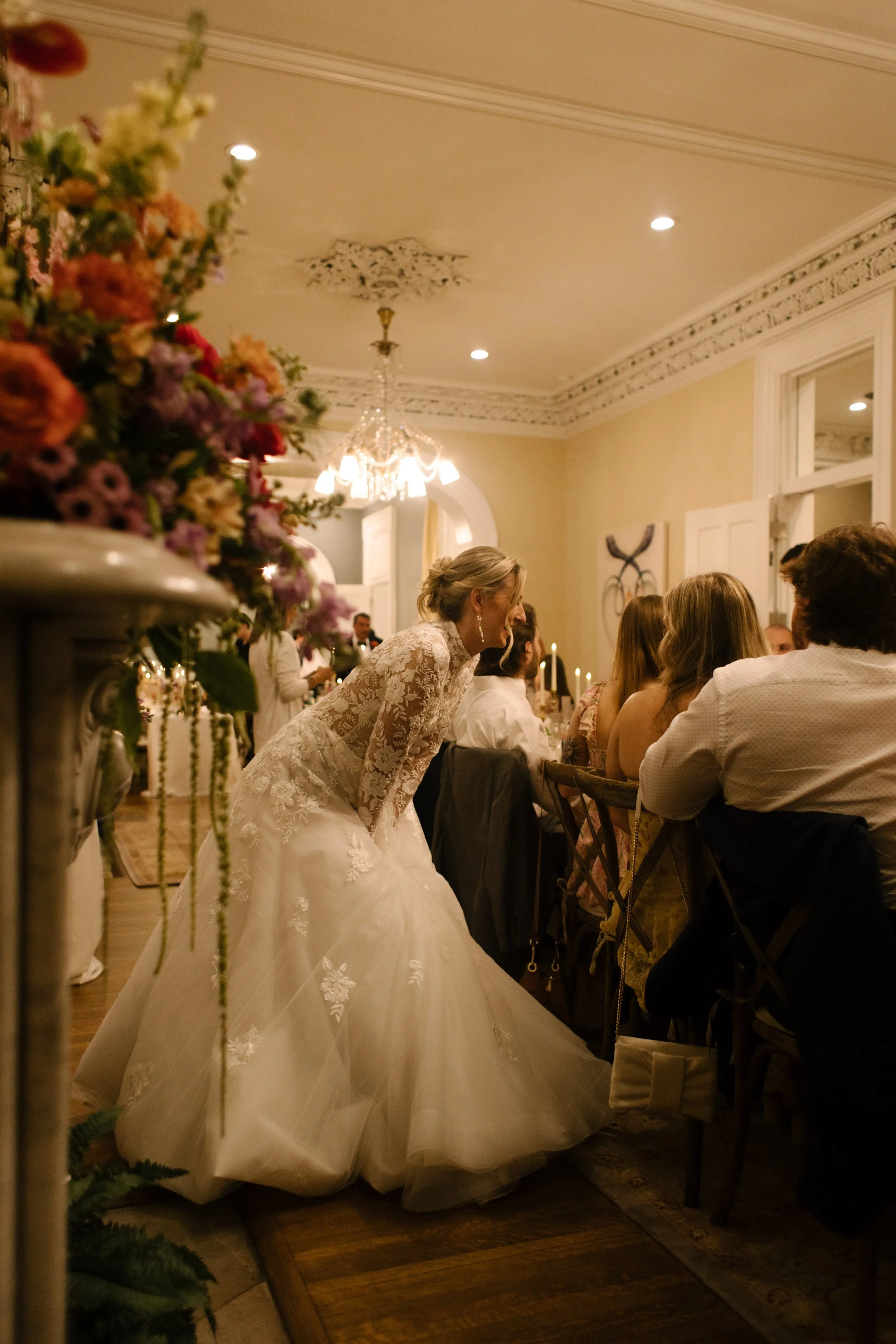 Romantic wedding table décor featuring colorful floral arrangements, taper candles, and personalized details