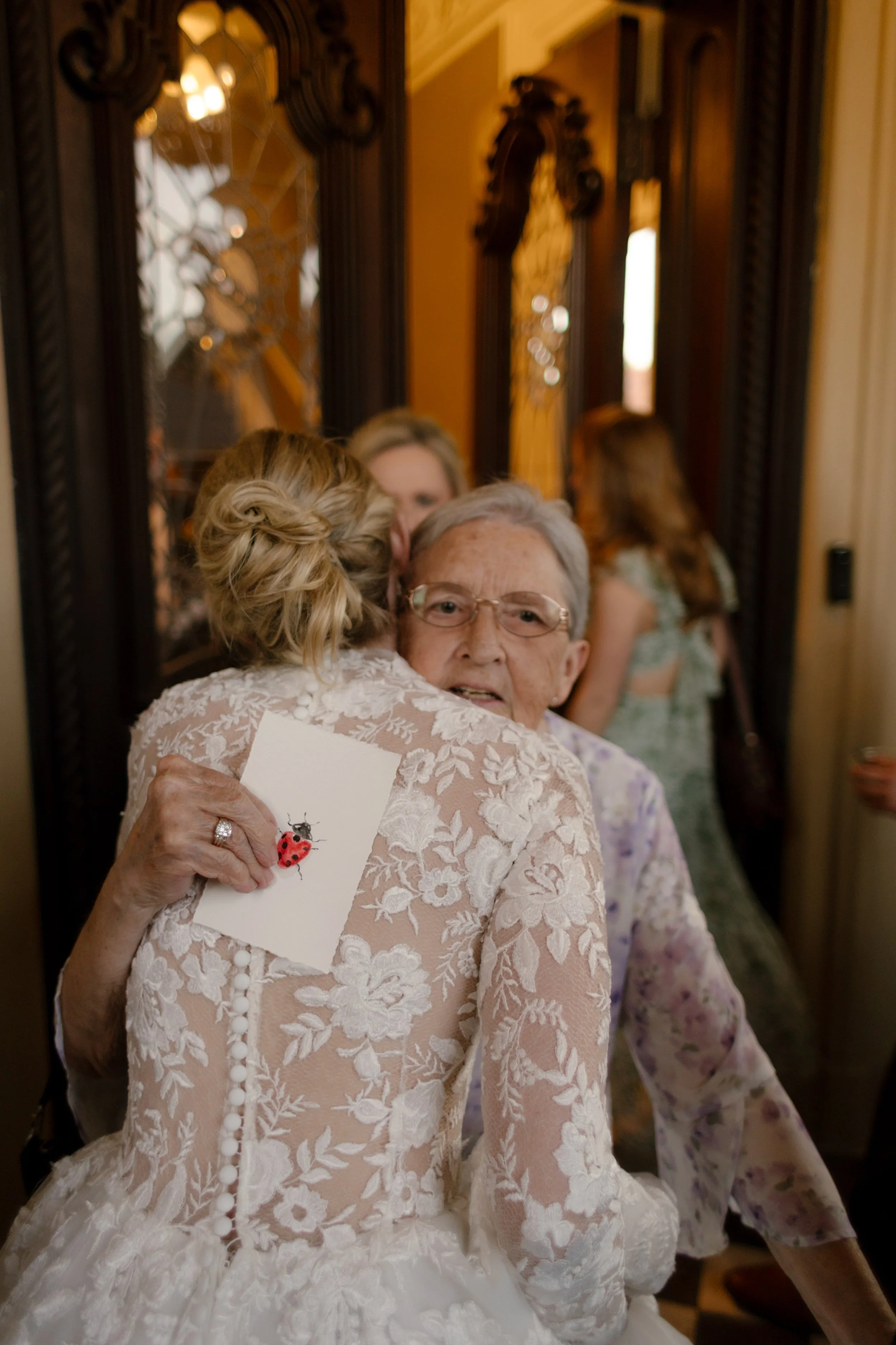 The bride sharing an emotional embrace with a loved one during an intimate wedding celebration