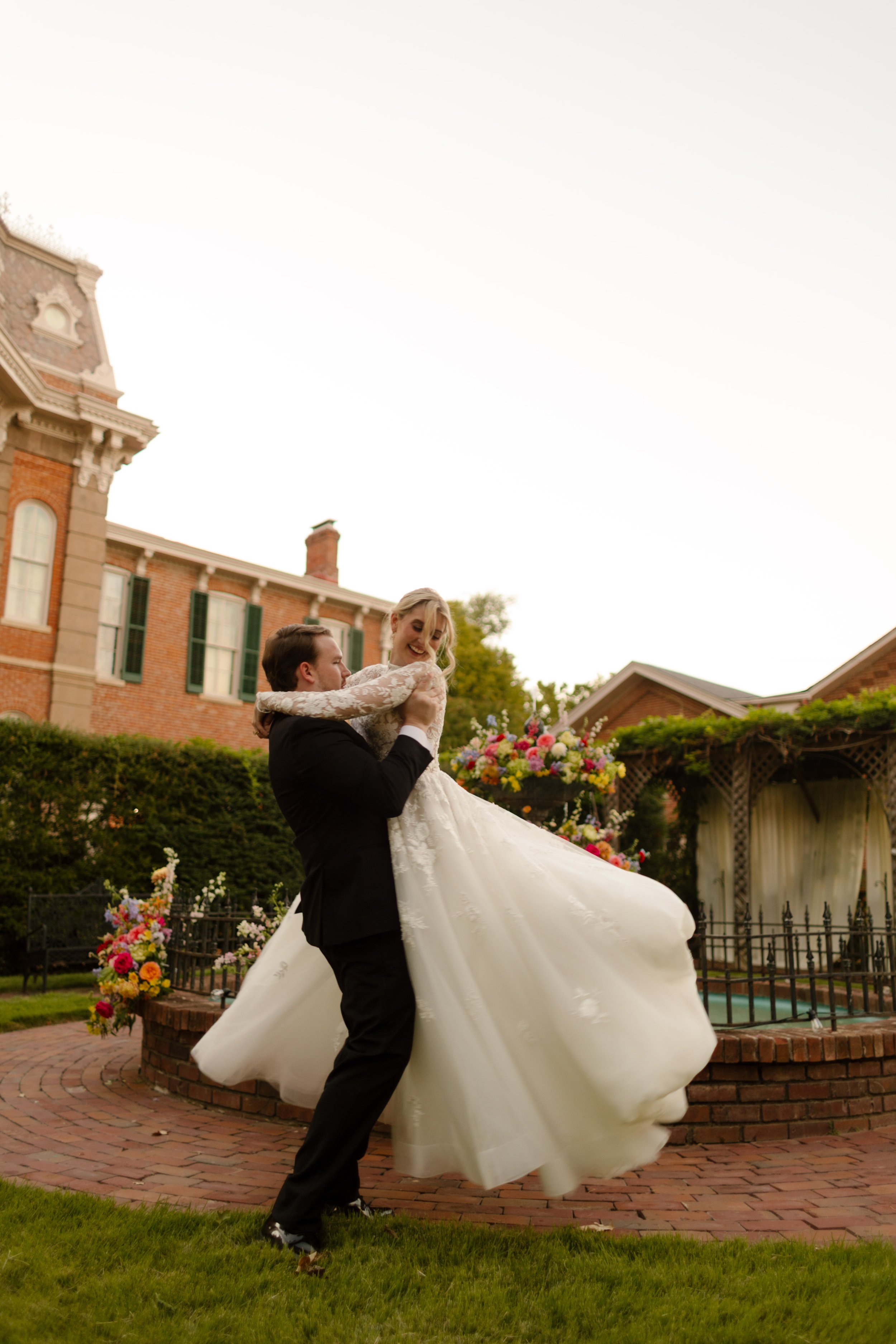 A candid portrait of the bride and groom enjoying a playful moment together during their wedding portraits