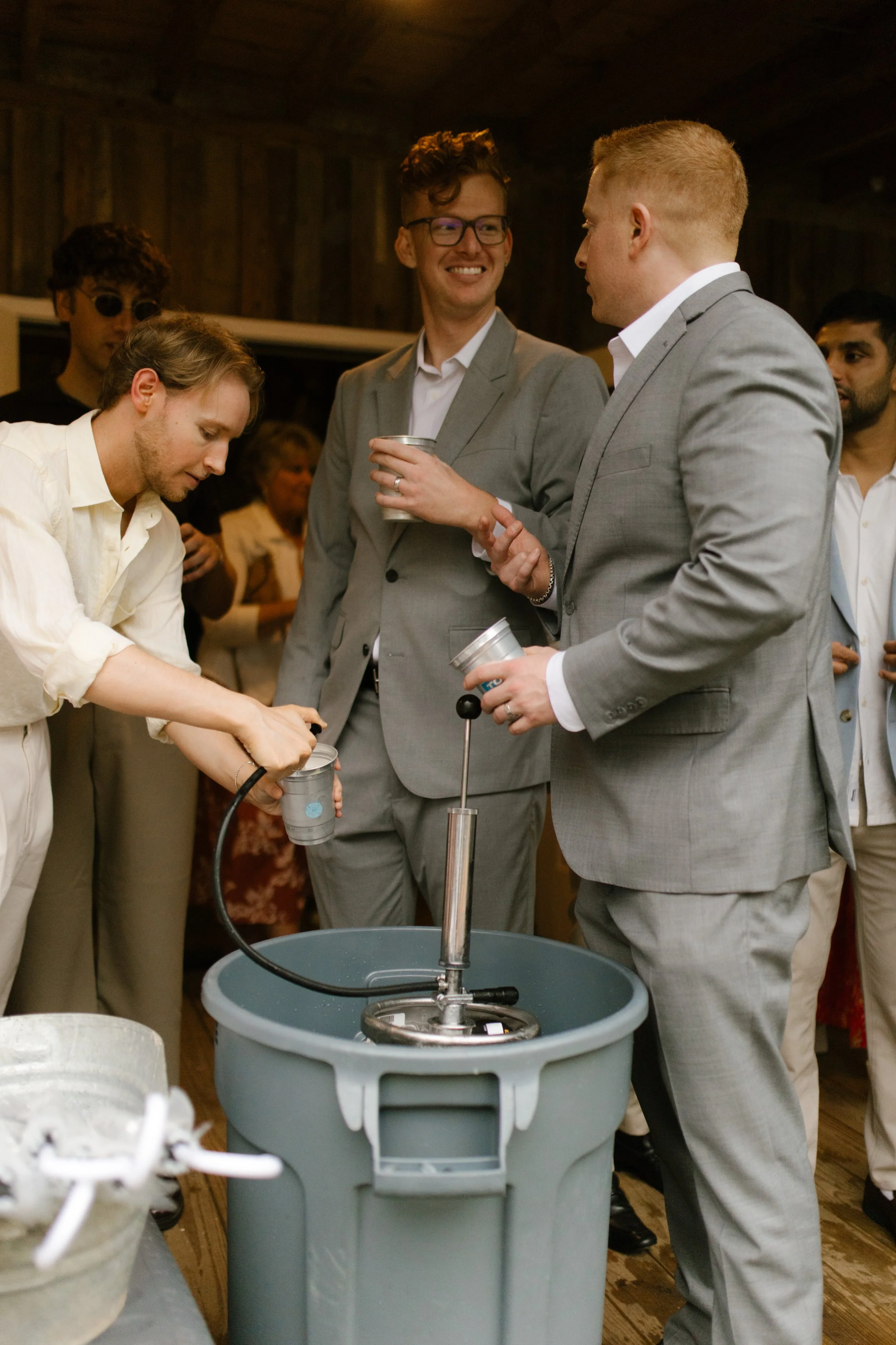 Wedding guests pouring drinks and socializing before a Southern wedding rehearsal dinner