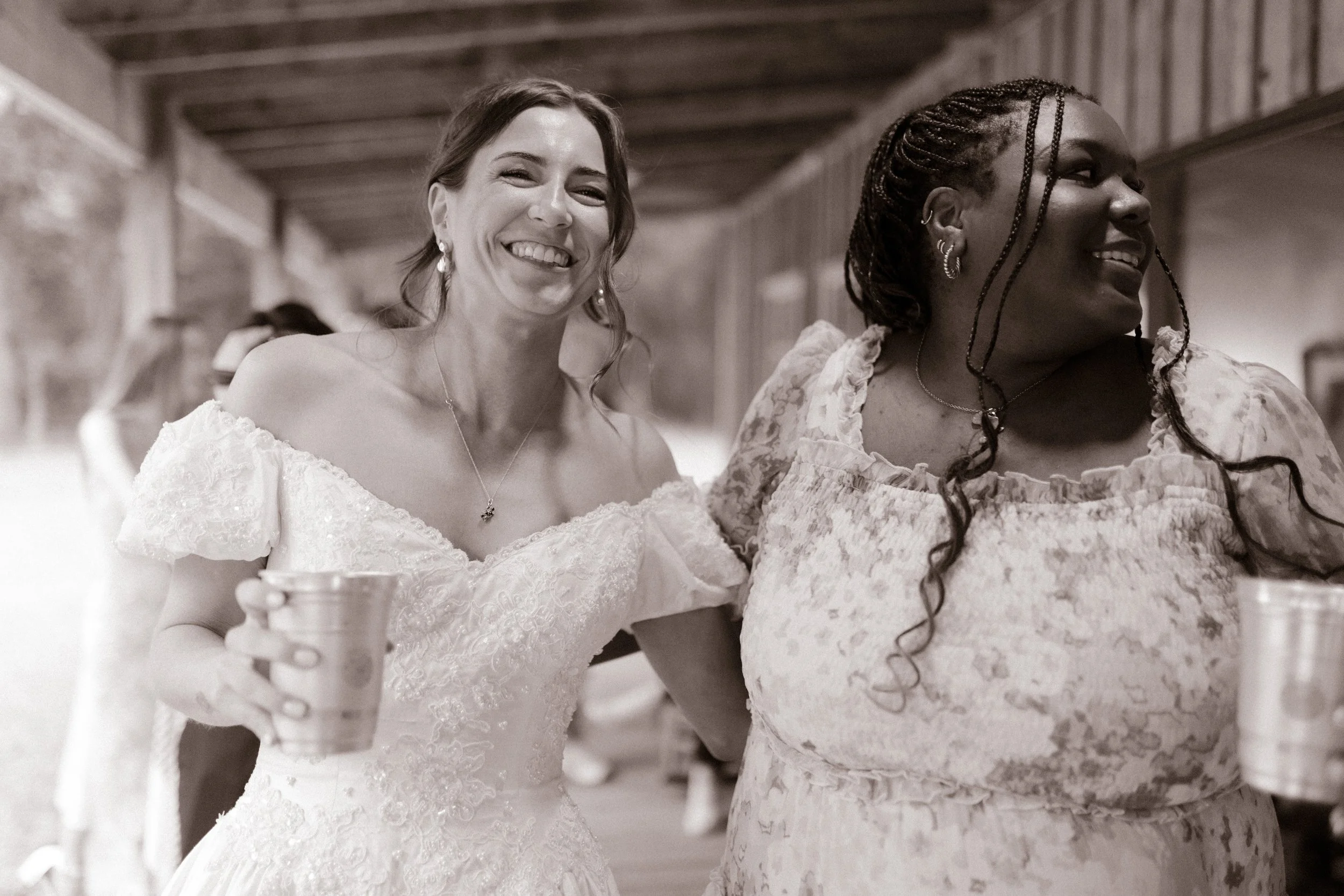 Bride sharing a candid moment with a friend during rehearsal dinner photography coverage