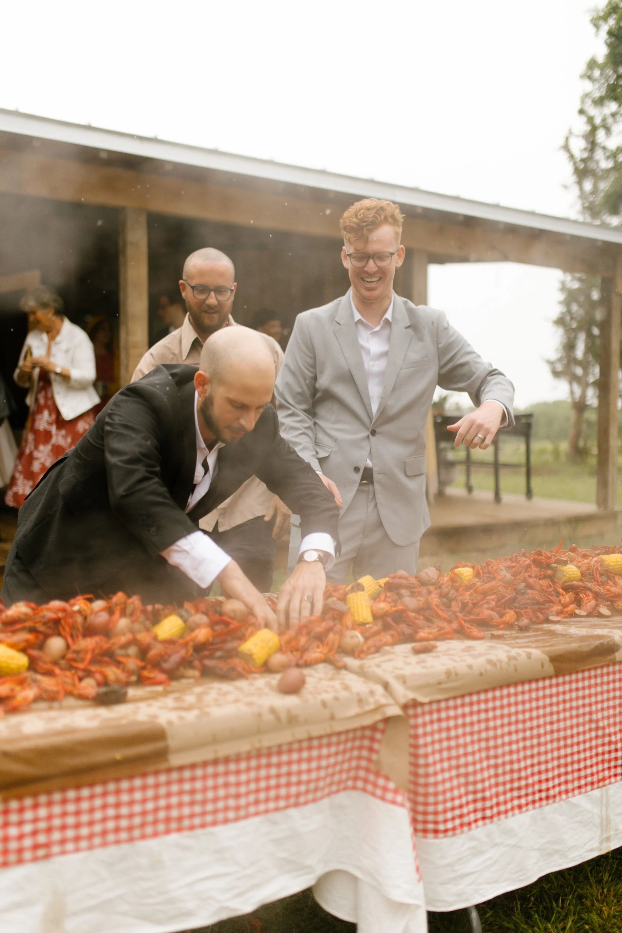 Close-up of the bride and groom enjoying a crawfish boil together during their wedding rehearsal dinner.