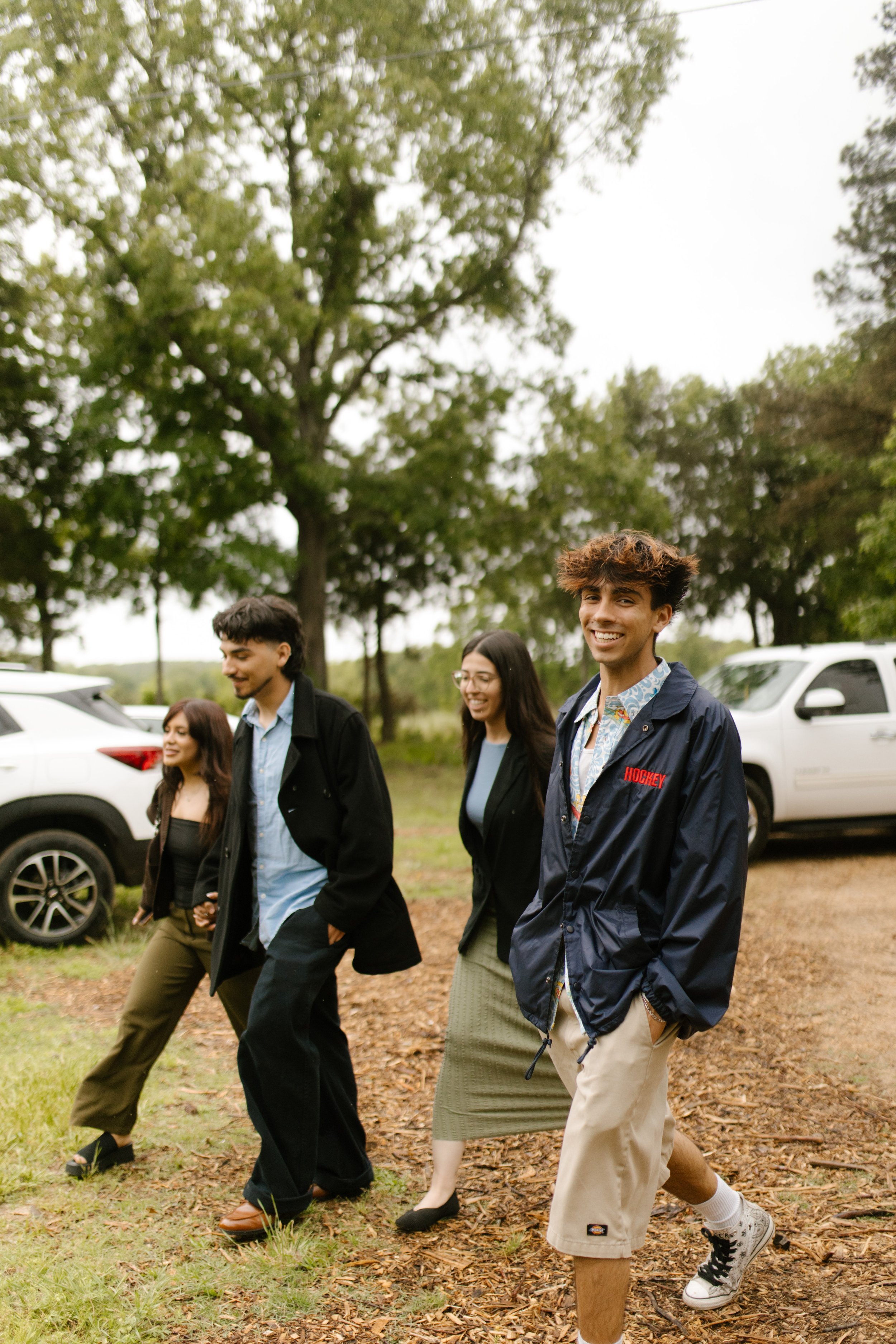 Friends arriving at the venue for wedding rehearsal photography and pre-wedding festivities.