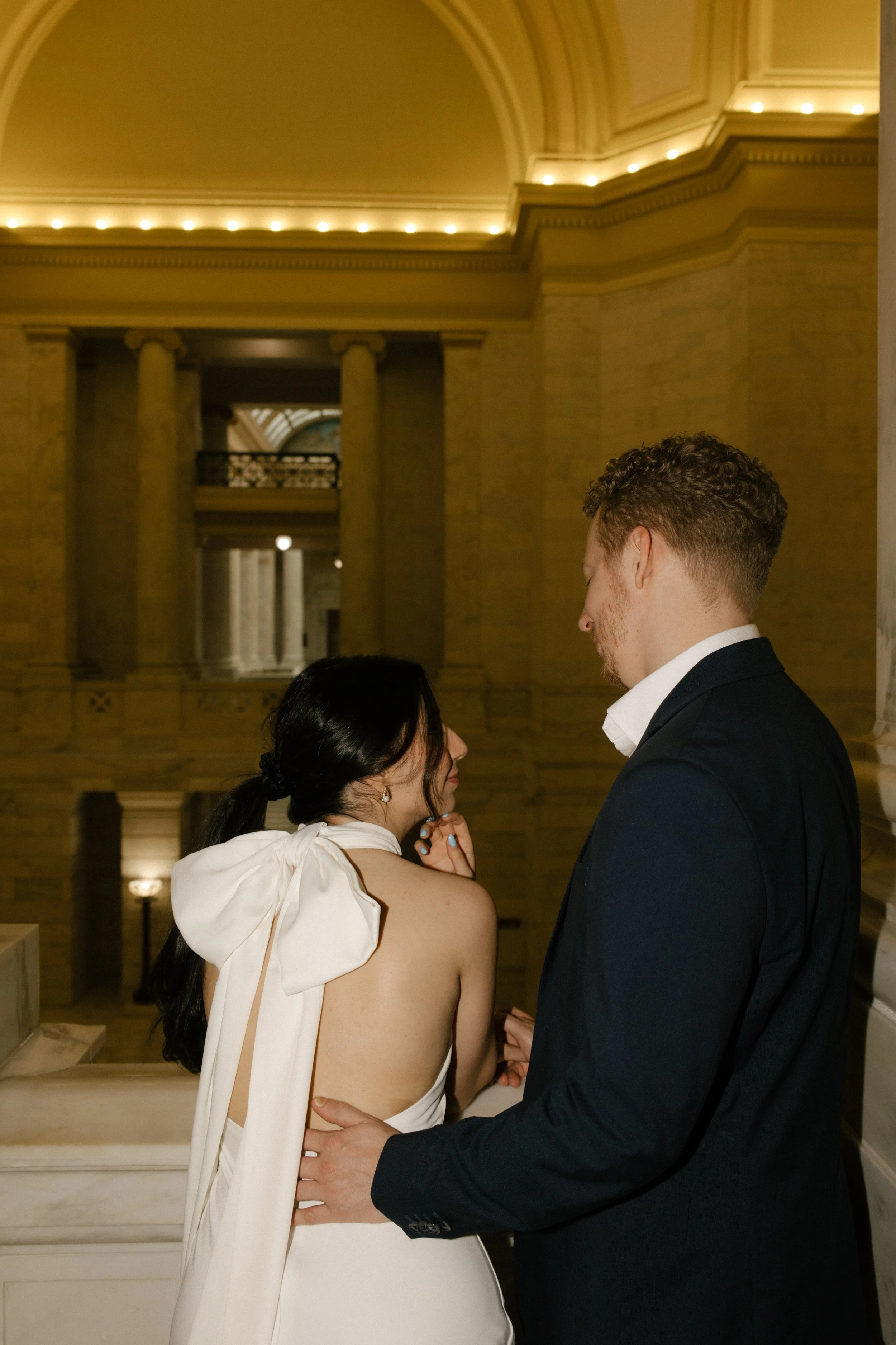 Couple sharing a quiet moment on an upper balcony during a courthouse engagement session