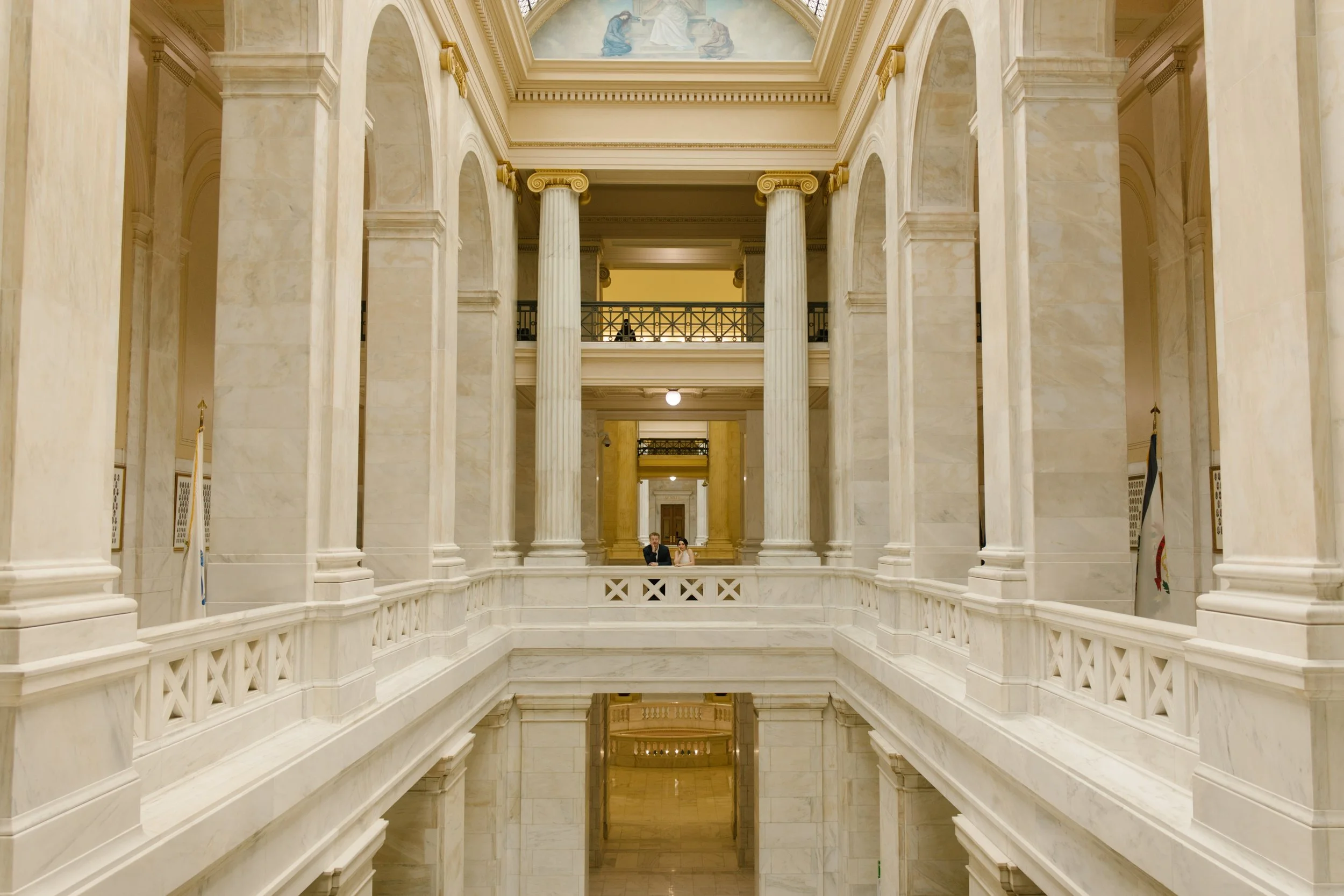 Editorial courthouse engagement photo highlighting the iconic marble columns and symmetry of the Little Rock Courthouse
