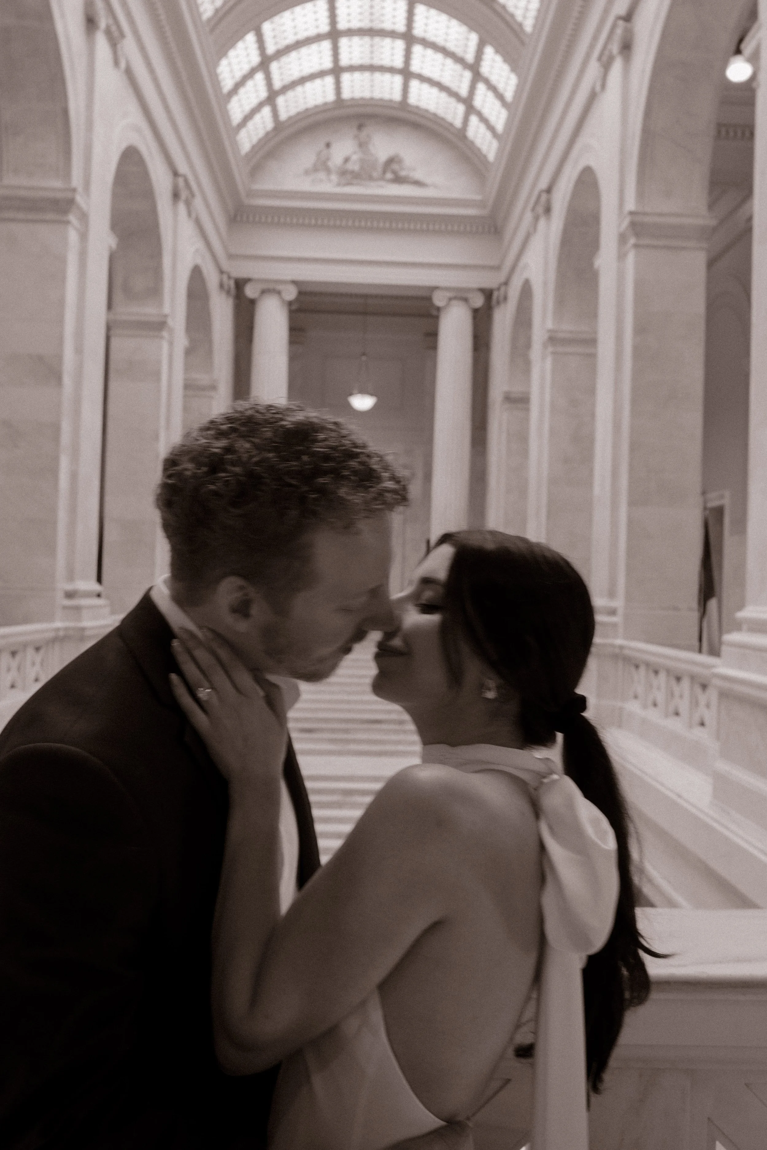 Timeless black and white engagement portrait framed by the elegant architecture of the Little Rock Courthouse