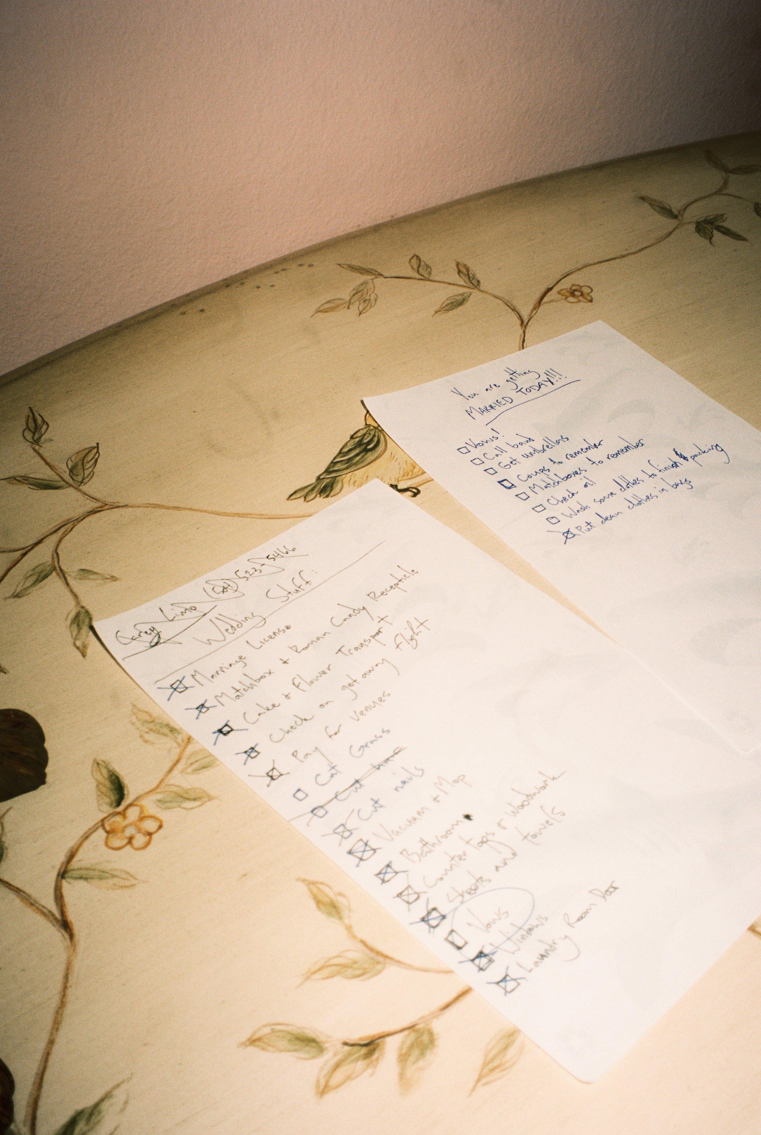 Handwritten wedding-day checklist and preparation notes displayed on a vintage tabletop.