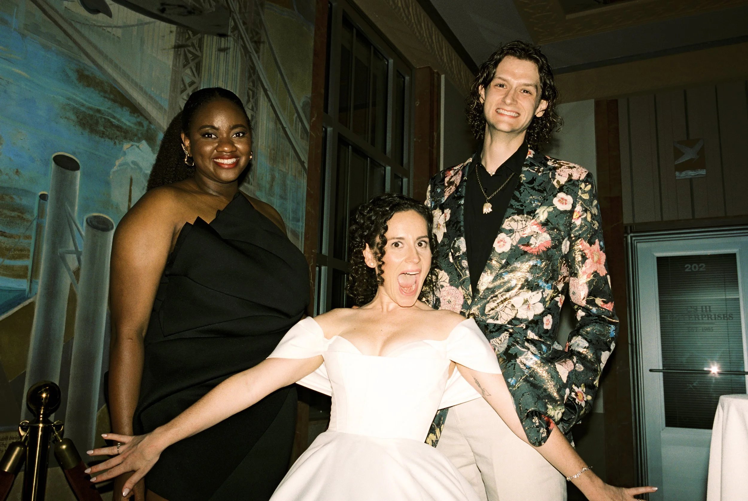 Bride poses playfully with friends during the reception in a candid documentary wedding photography moment.