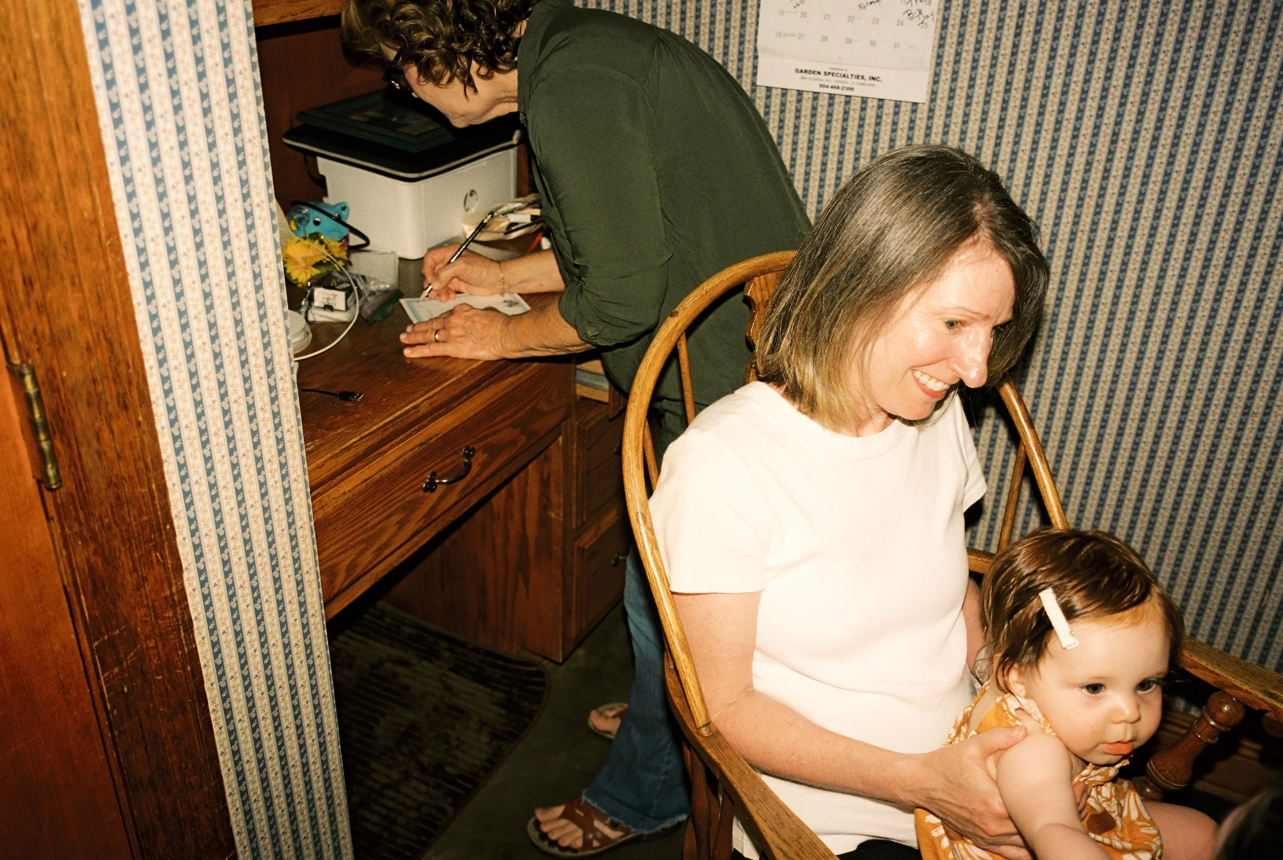 Family members spend quiet time together indoors before the ceremony in an authentic documentary wedding photography scene.