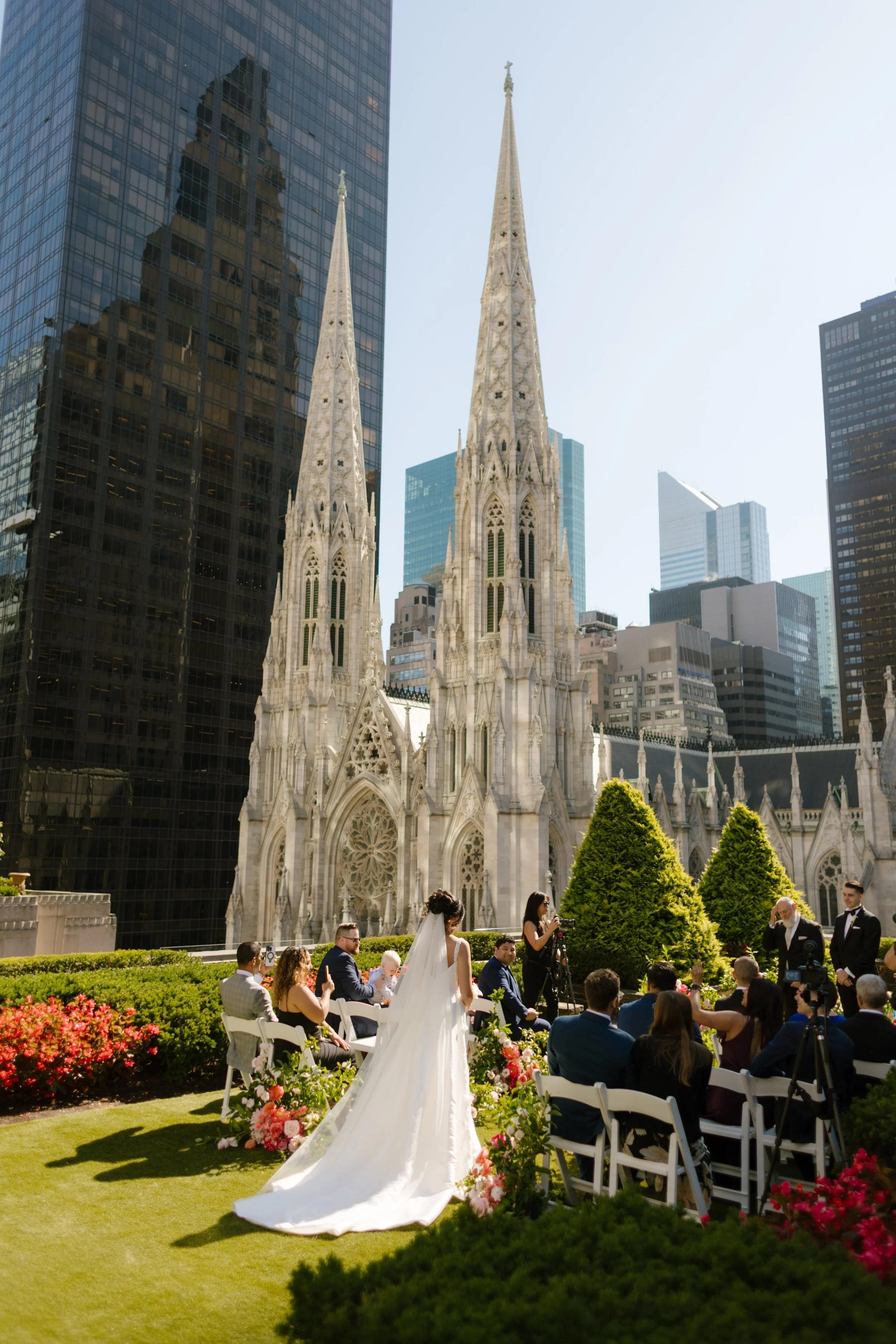 Outdoor wedding ceremony with St. Patrick's Cathedral rising above the skyline, one of the most iconic Wedding Locations in NYC.
