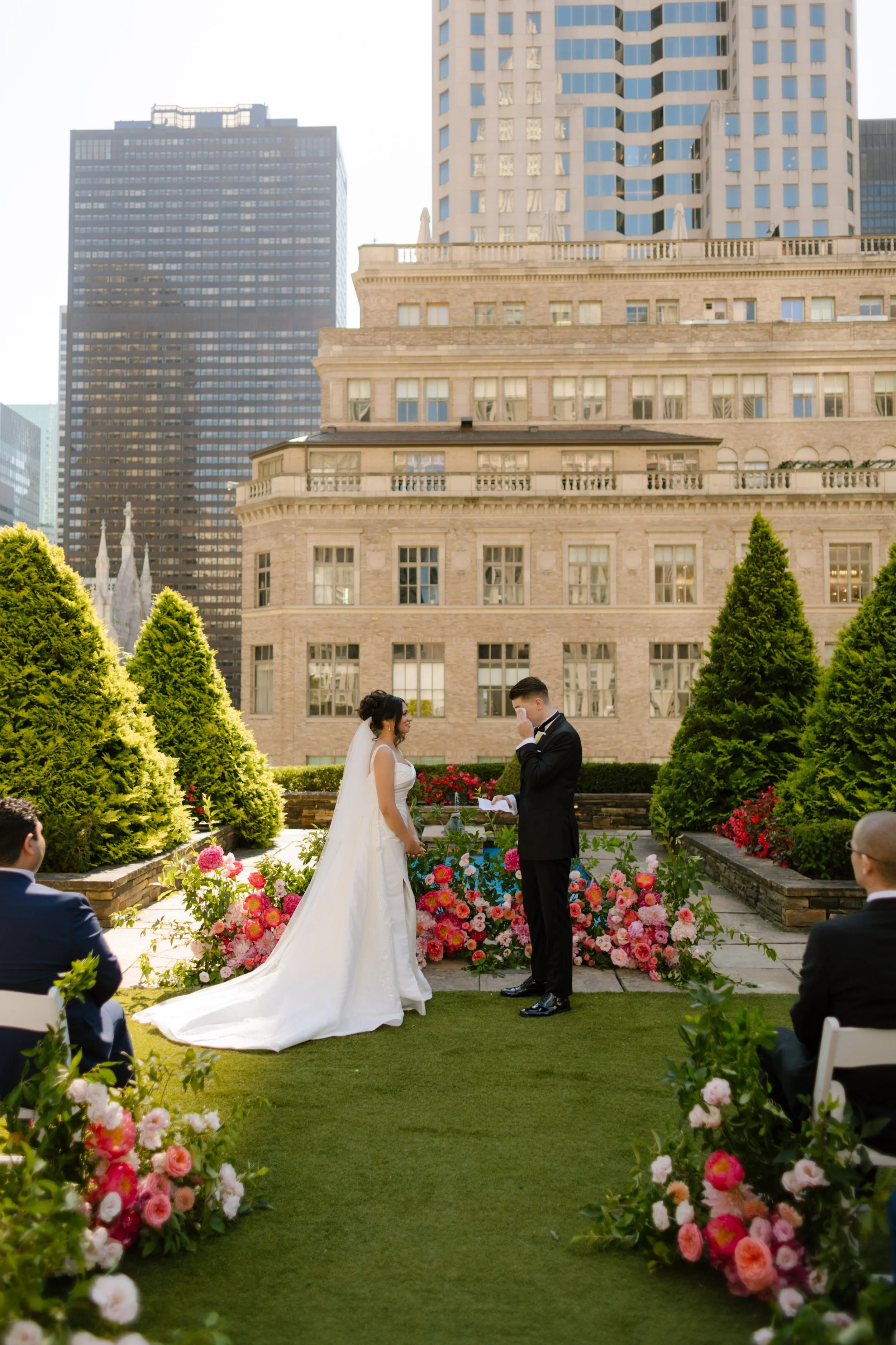 Elegant rooftop wedding ceremony with colorful florals and the Manhattan skyline at one of the most luxurious Wedding Locations in NYC.