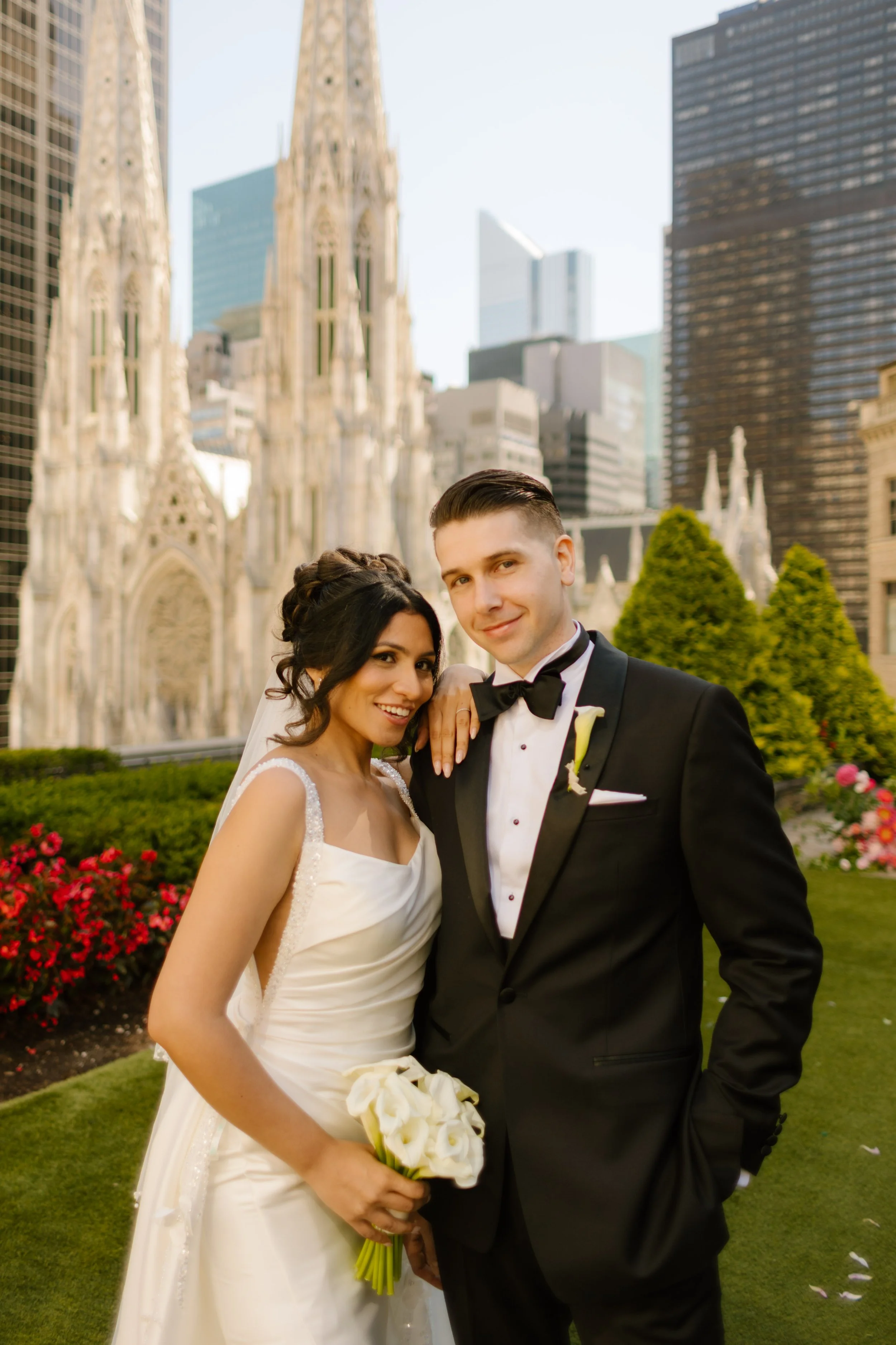 Bride and groom embrace beneath the veil on a rooftop overlooking St. Patrick's Cathedral, showcasing one of the most unforgettable Wedding Locations in NYC.