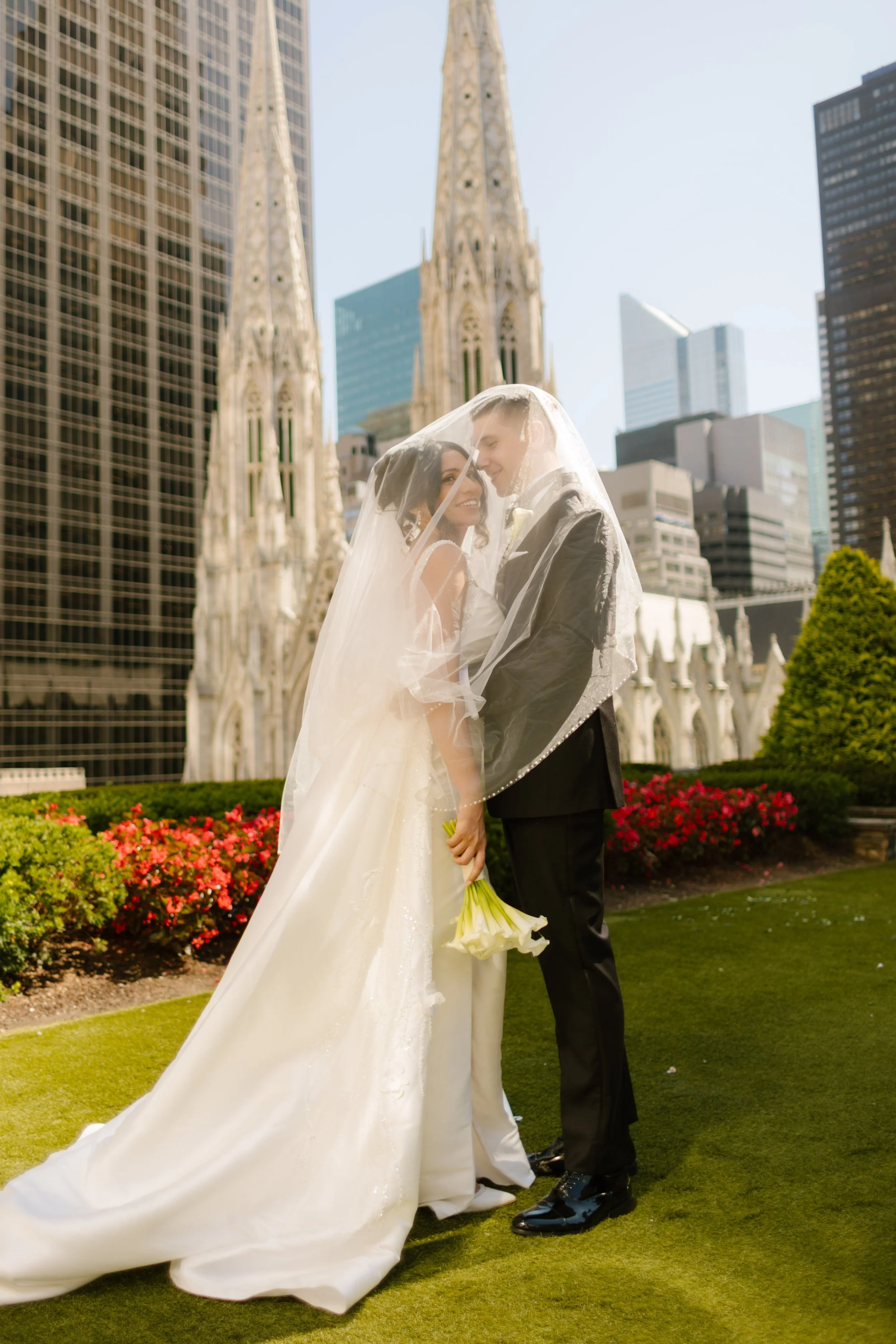 Newlyweds pose together in front of St. Patrick's Cathedral after their rooftop wedding at one of the most breathtaking Wedding Locations in NYC.