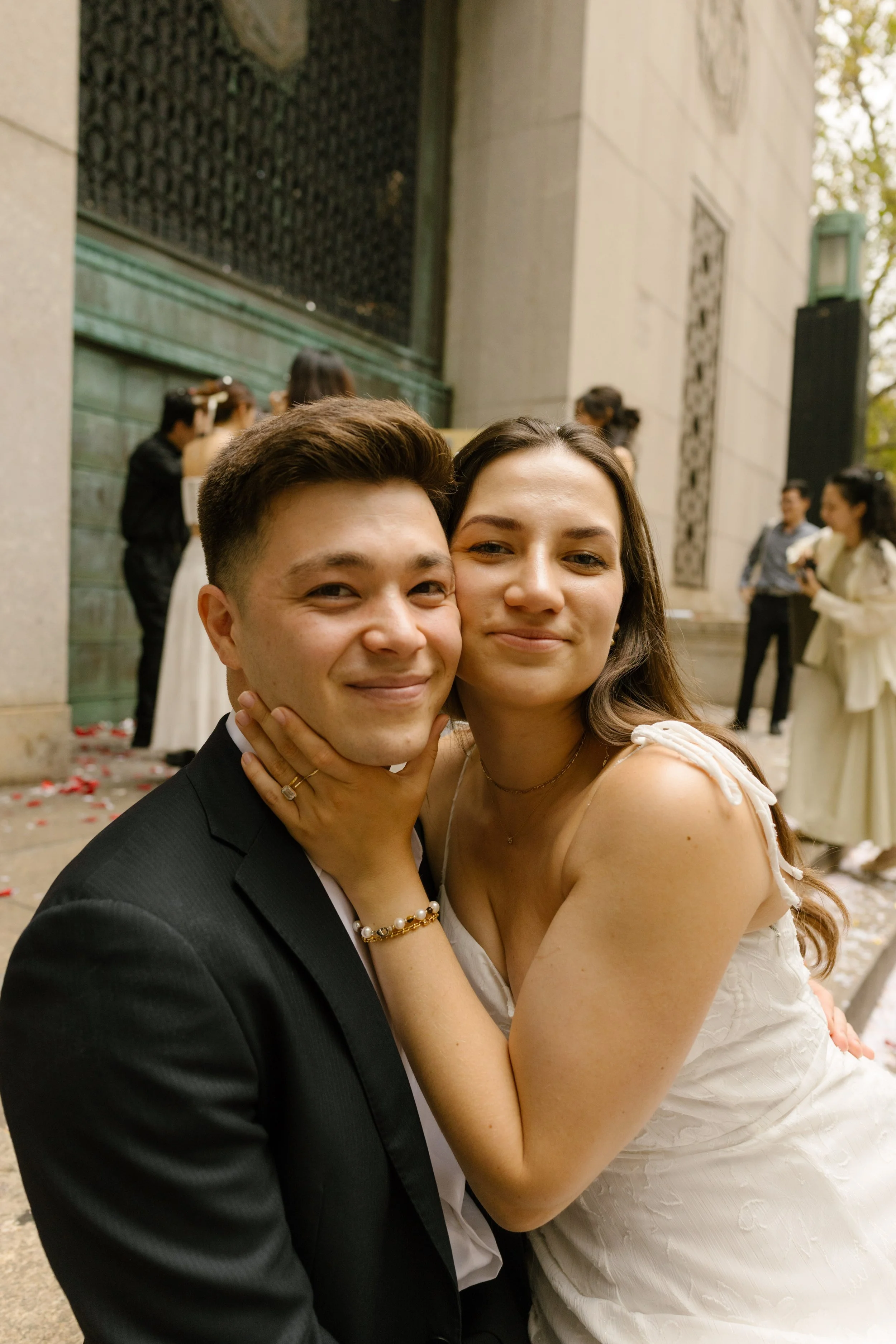 Newlyweds smile together outside the courthouse after their intimate ceremony at one of the most memorable Wedding Locations in NYC.