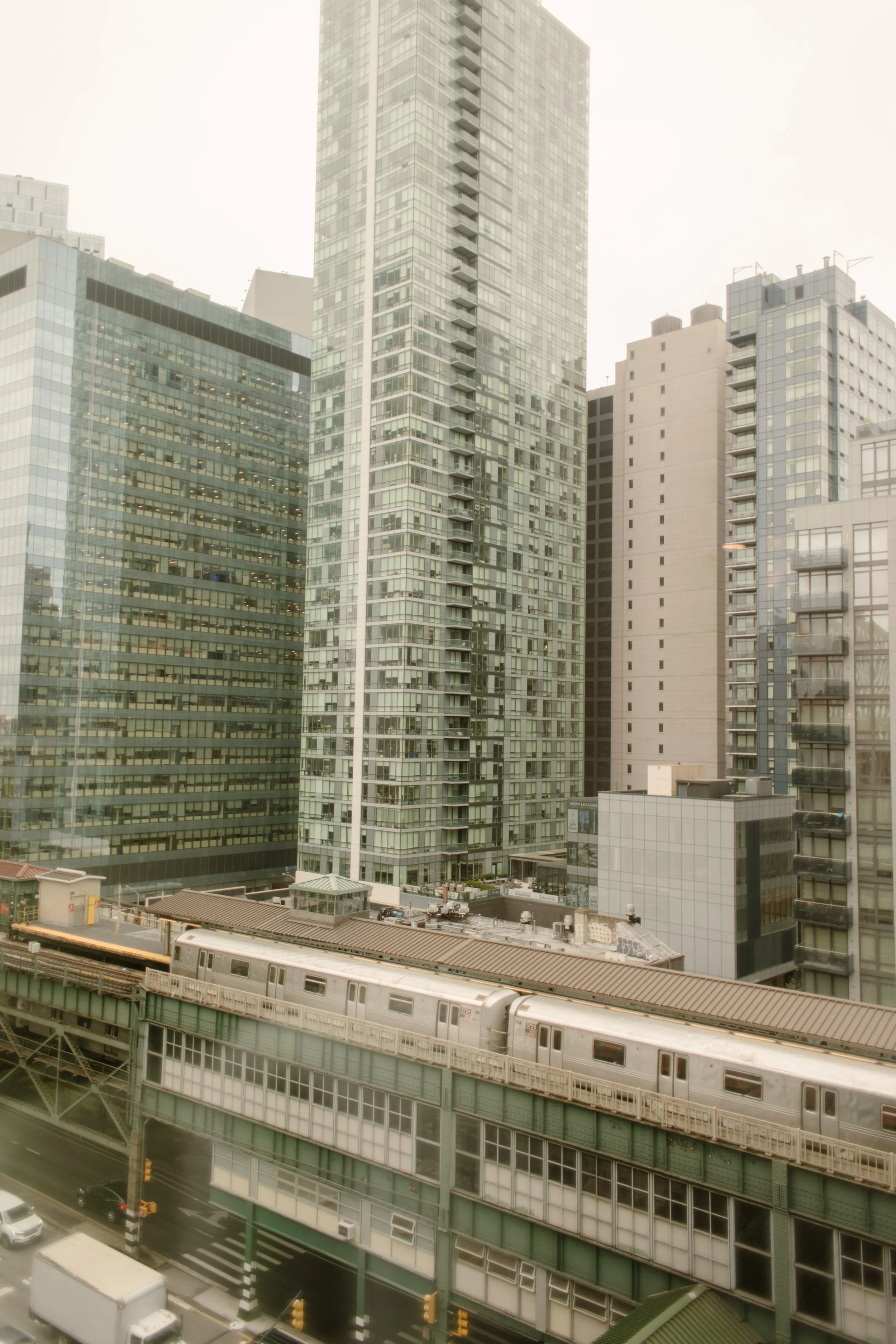 View of the New York City skyline and elevated subway tracks outside the couple's apartment on their wedding day.