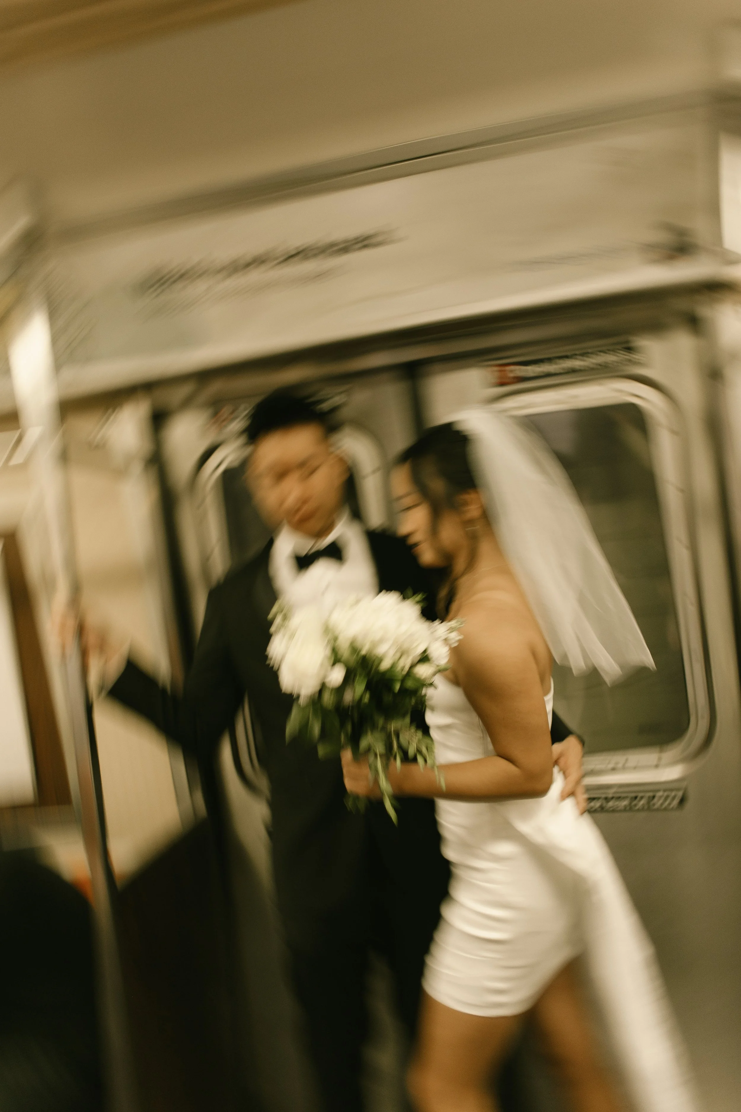 Newlyweds step onto a New York City subway after their intimate courthouse ceremony.