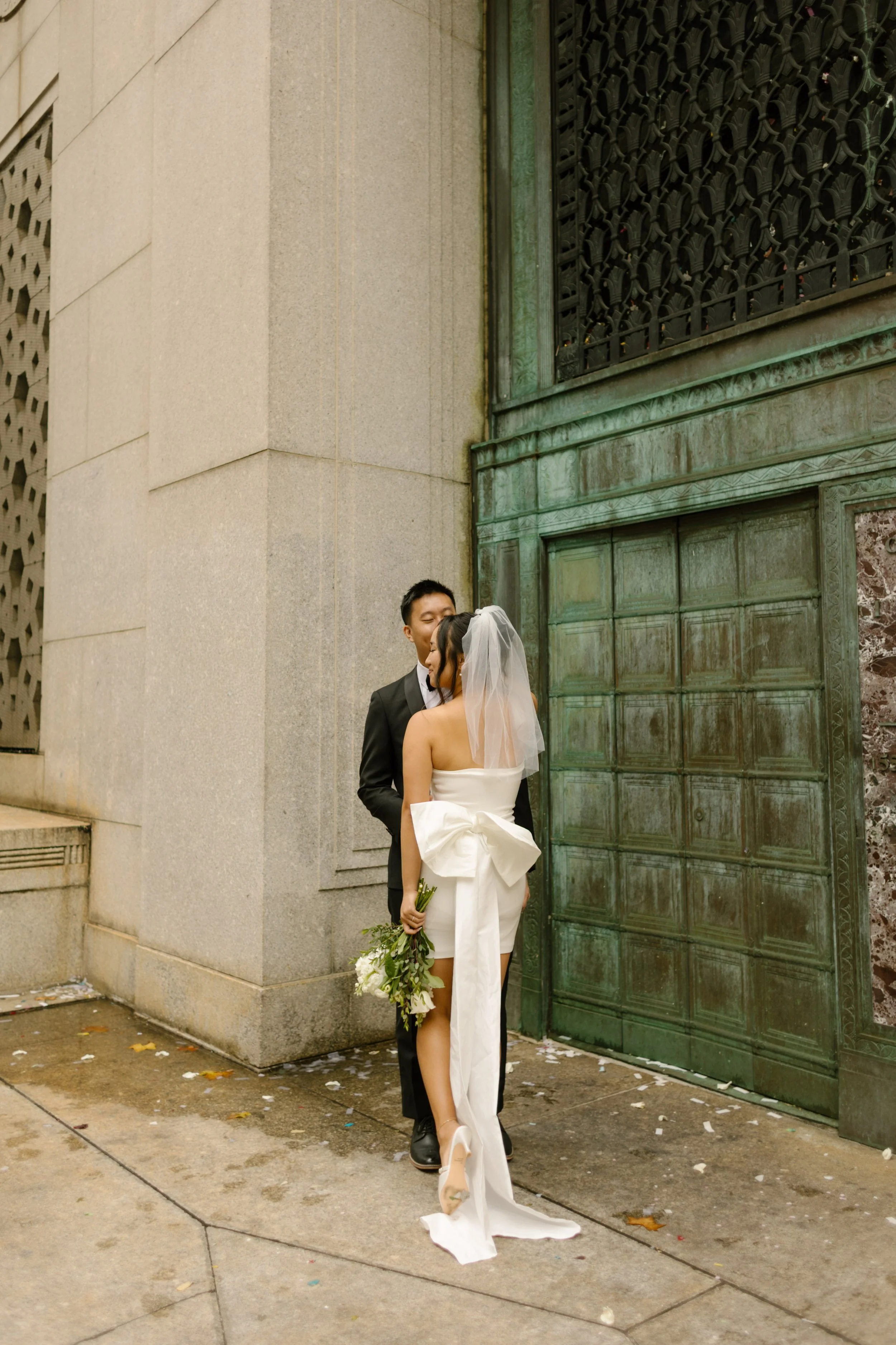 Bride and groom share a quiet moment outside the courthouse following their nyc courthouse wedding.