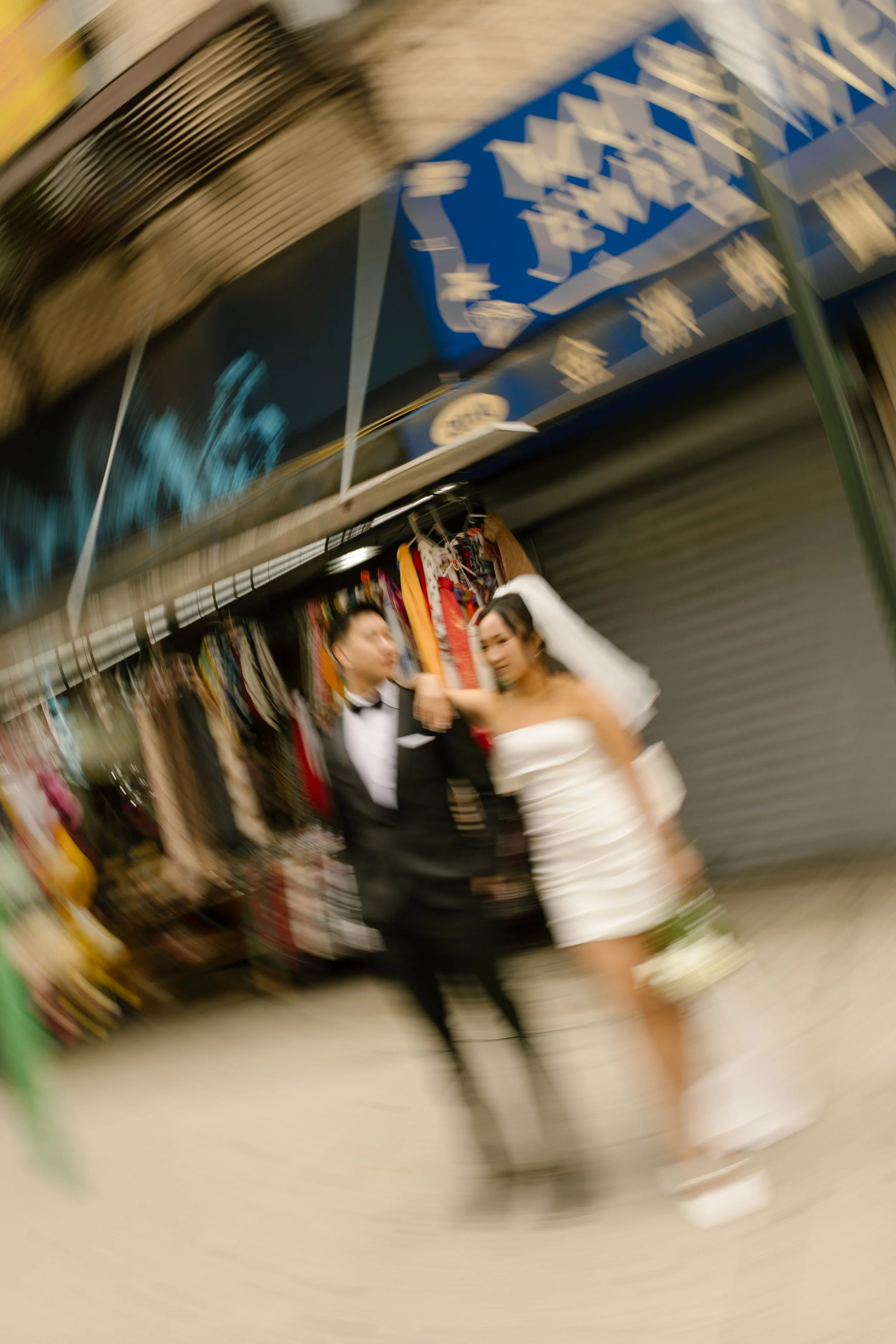Newlyweds share a kiss on a Little Italy sidewalk following their nyc courthouse wedding.