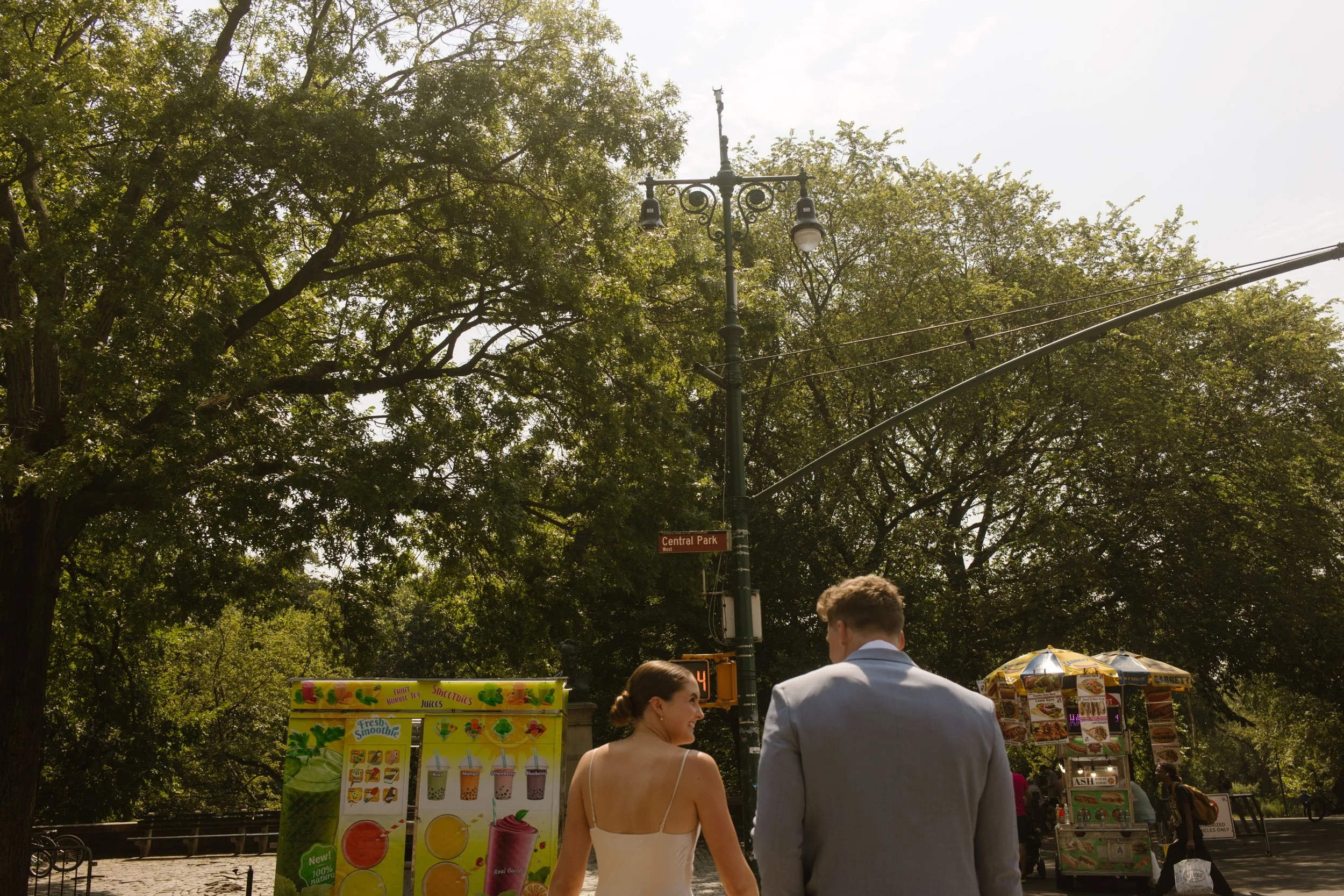 Bride and groom walking toward their ceremony location near Central Park during their wedding day timeline.