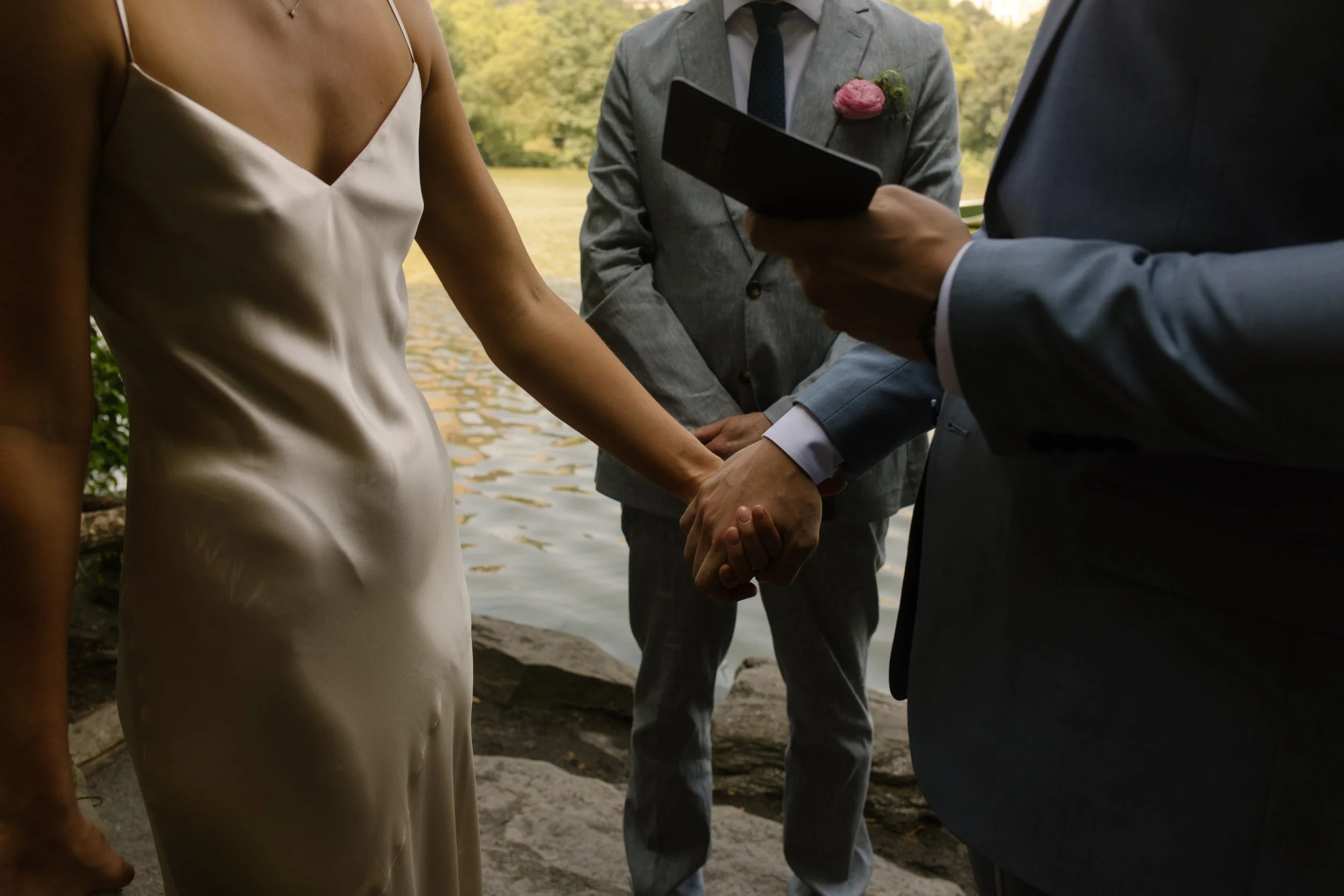 Bride and groom holding hands during their vows, a meaningful part of the wedding day timeline.