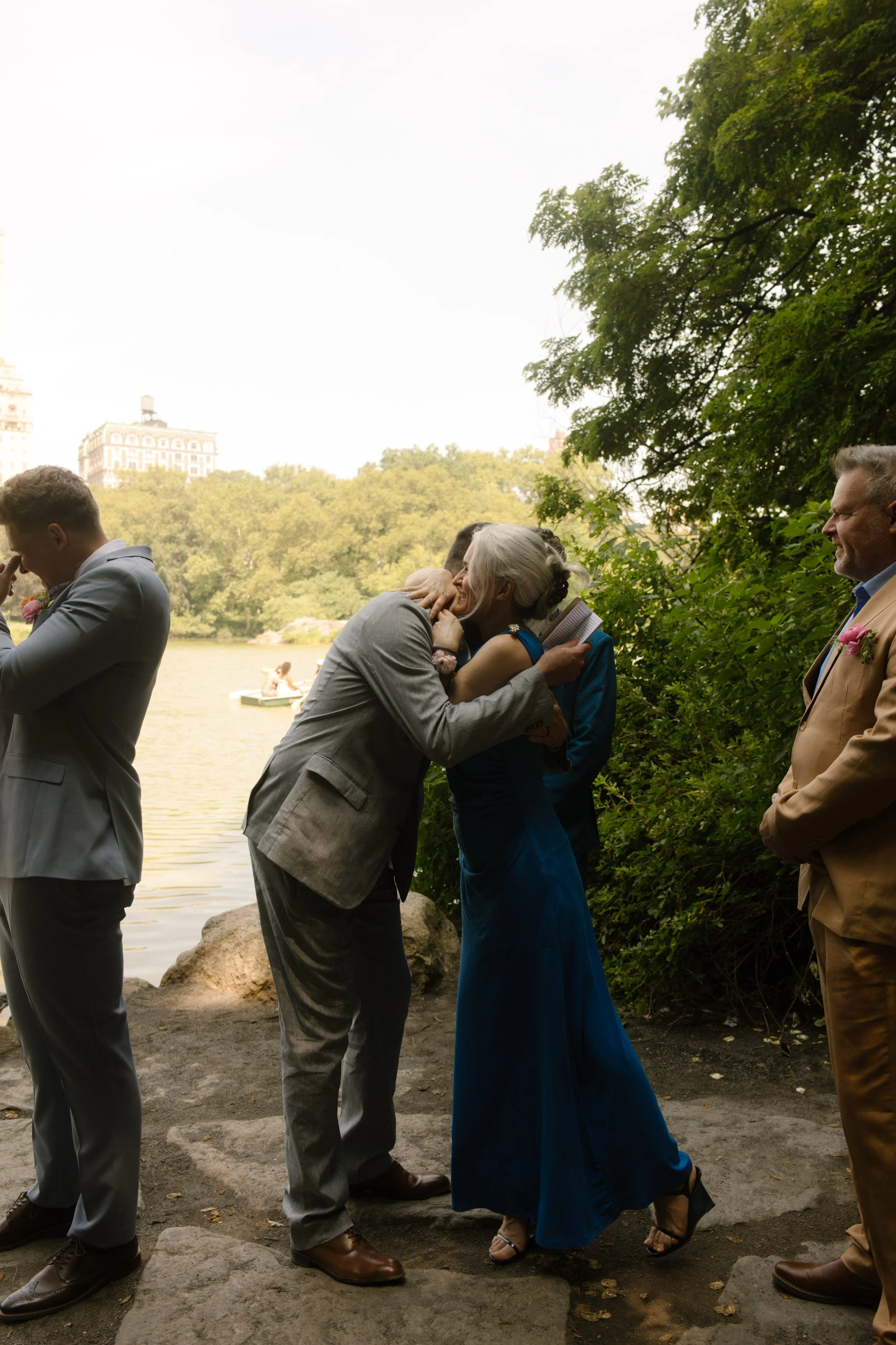 Groom hugging his mother before the ceremony during an emotional moment in the wedding day timeline.