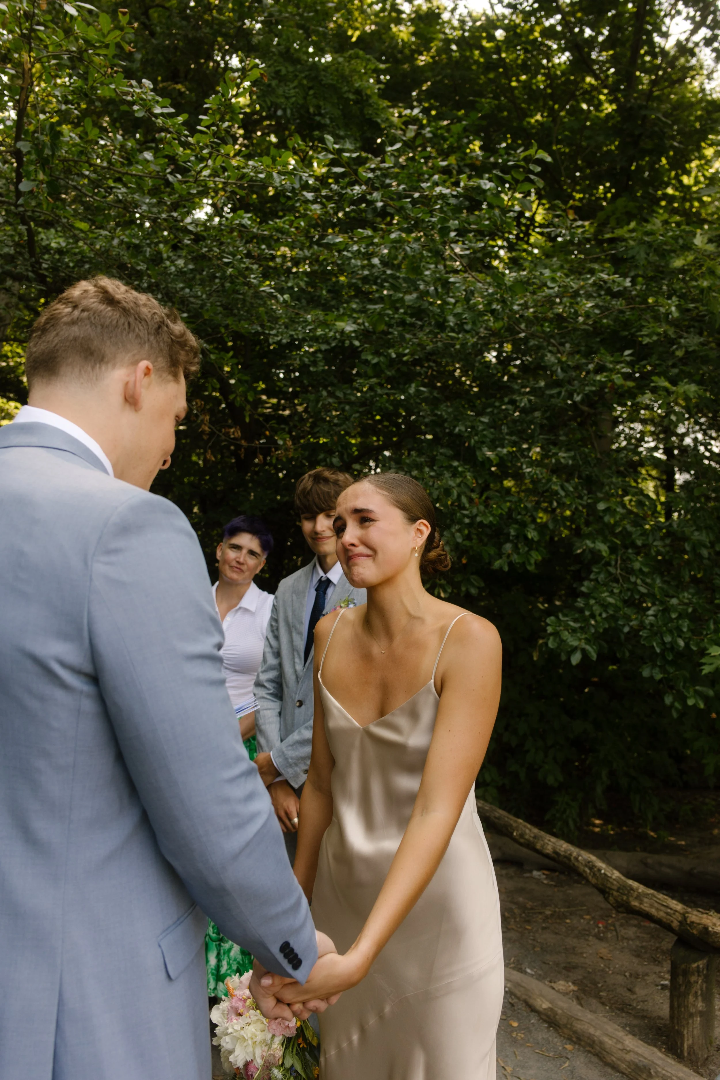 Bride holding the groom's hands during an emotional moment as they exchange vows.