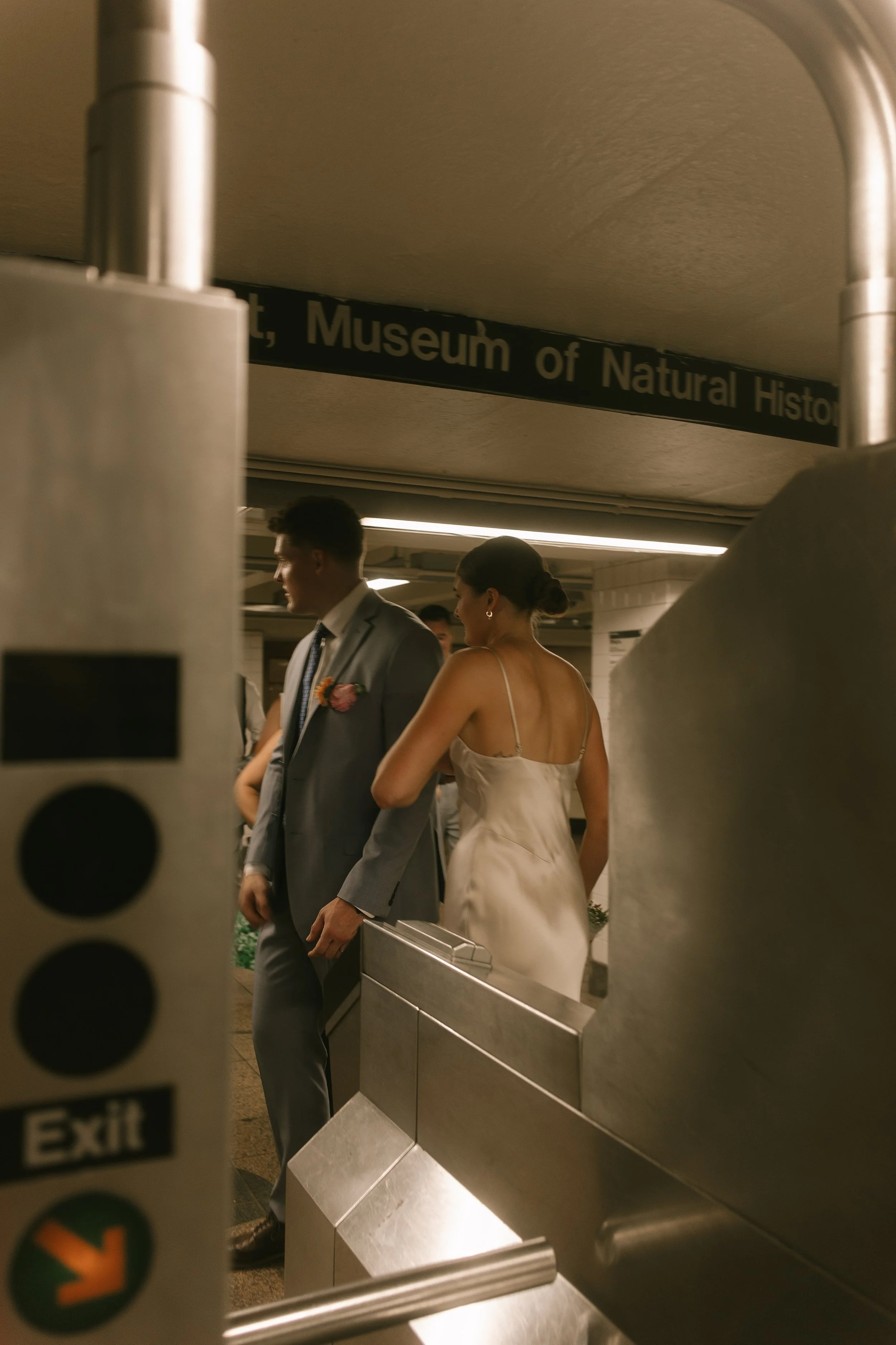 Bride and groom exiting the subway at the Museum of Natural History stop during their wedding day timeline adventure.