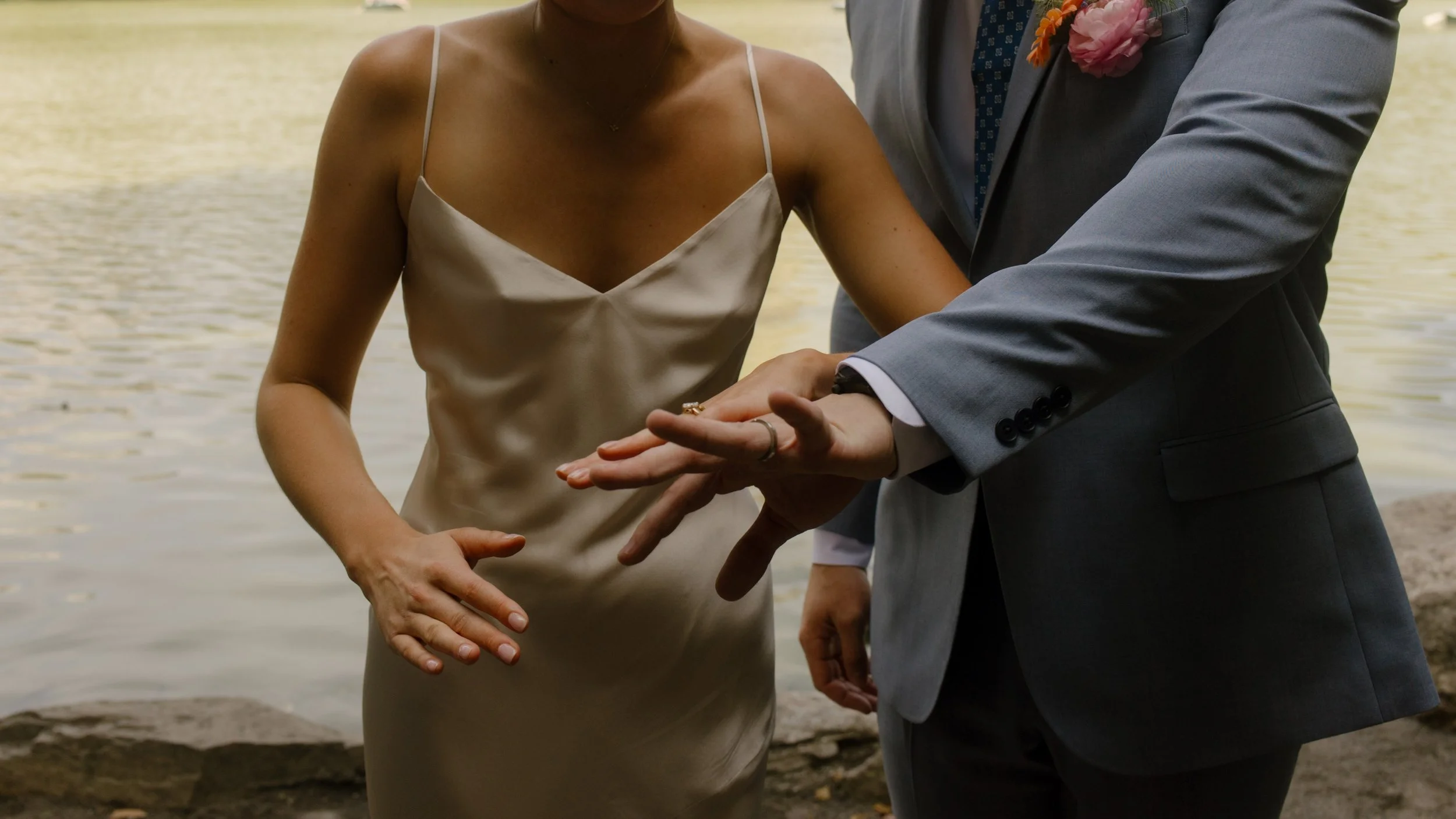 Close-up of the couple exchanging rings during their intimate ceremony, a meaningful moment in the wedding day timeline.