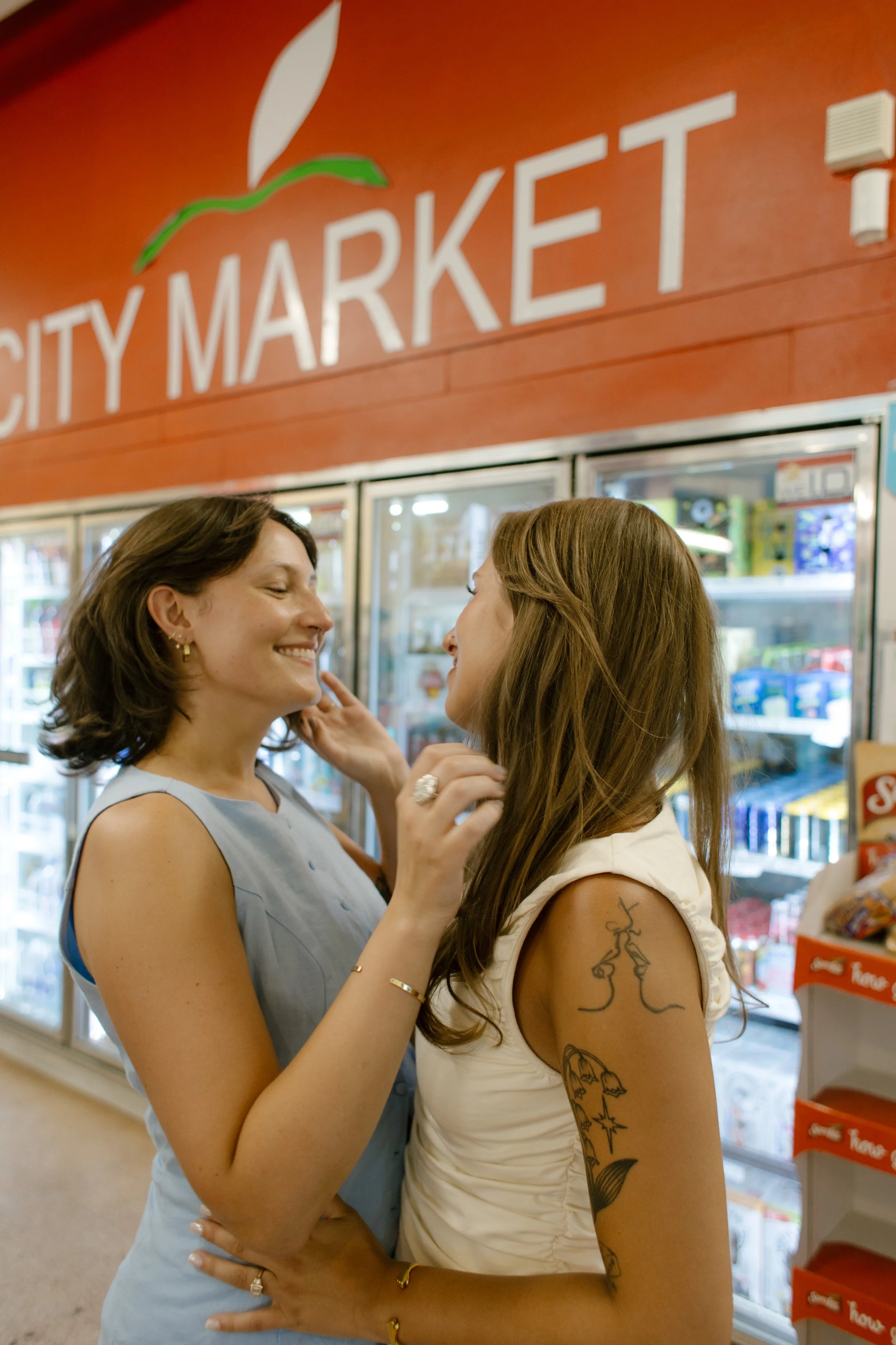 Couple shares a quiet moment together inside a neighborhood market.