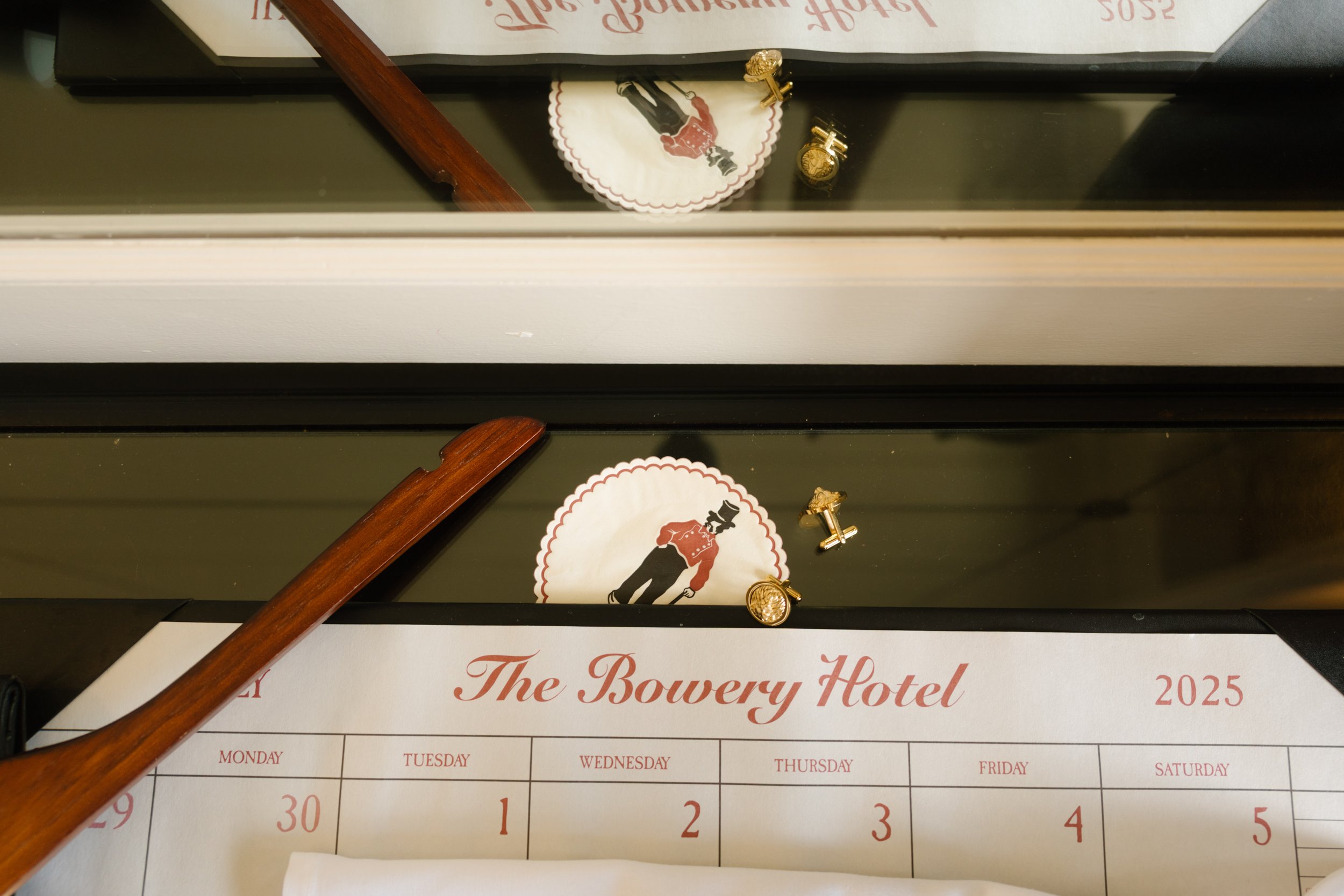 Wedding accessories arranged beside a Bowery Hotel calendar at one of the distinctive NYC hotels.