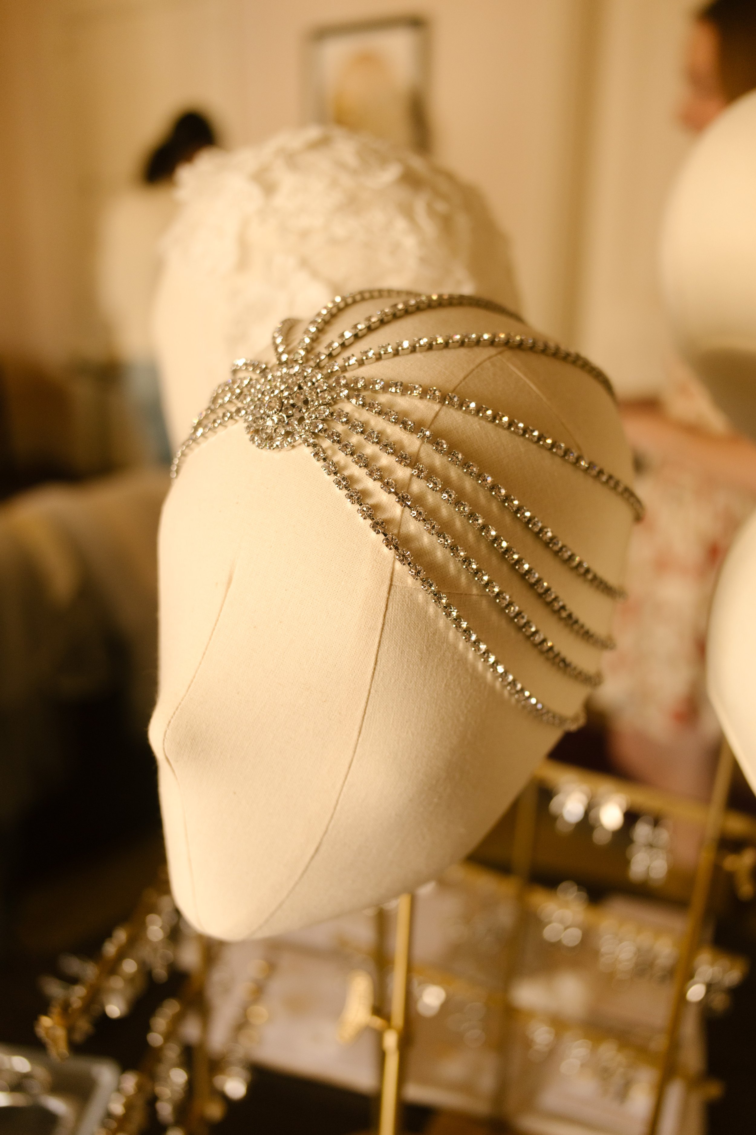 Vintage-inspired bridal headpiece displayed among wedding accessories during bridal details photography.