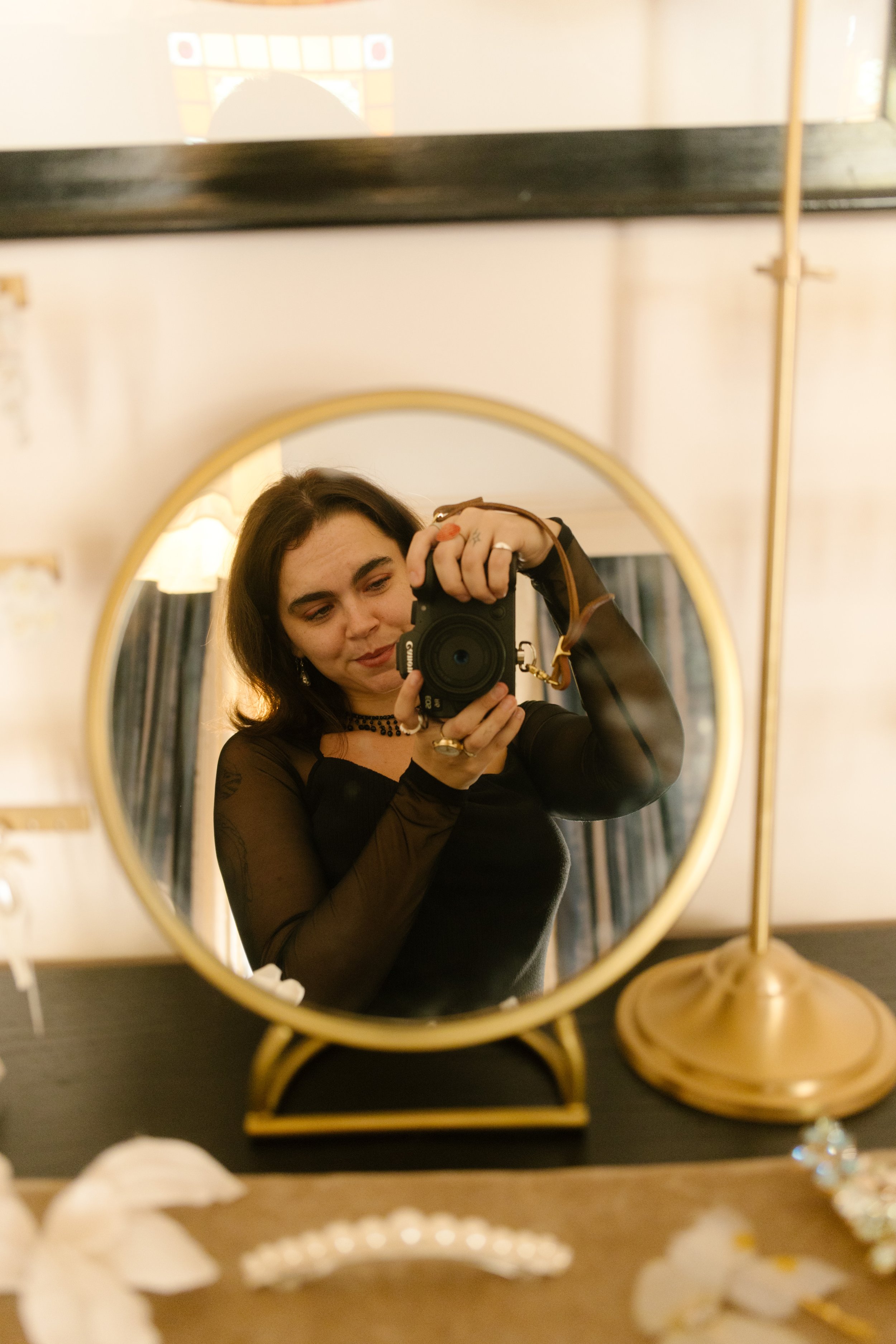 Photographer taking a self-portrait in a round mirror inside one of the NYC hotels.