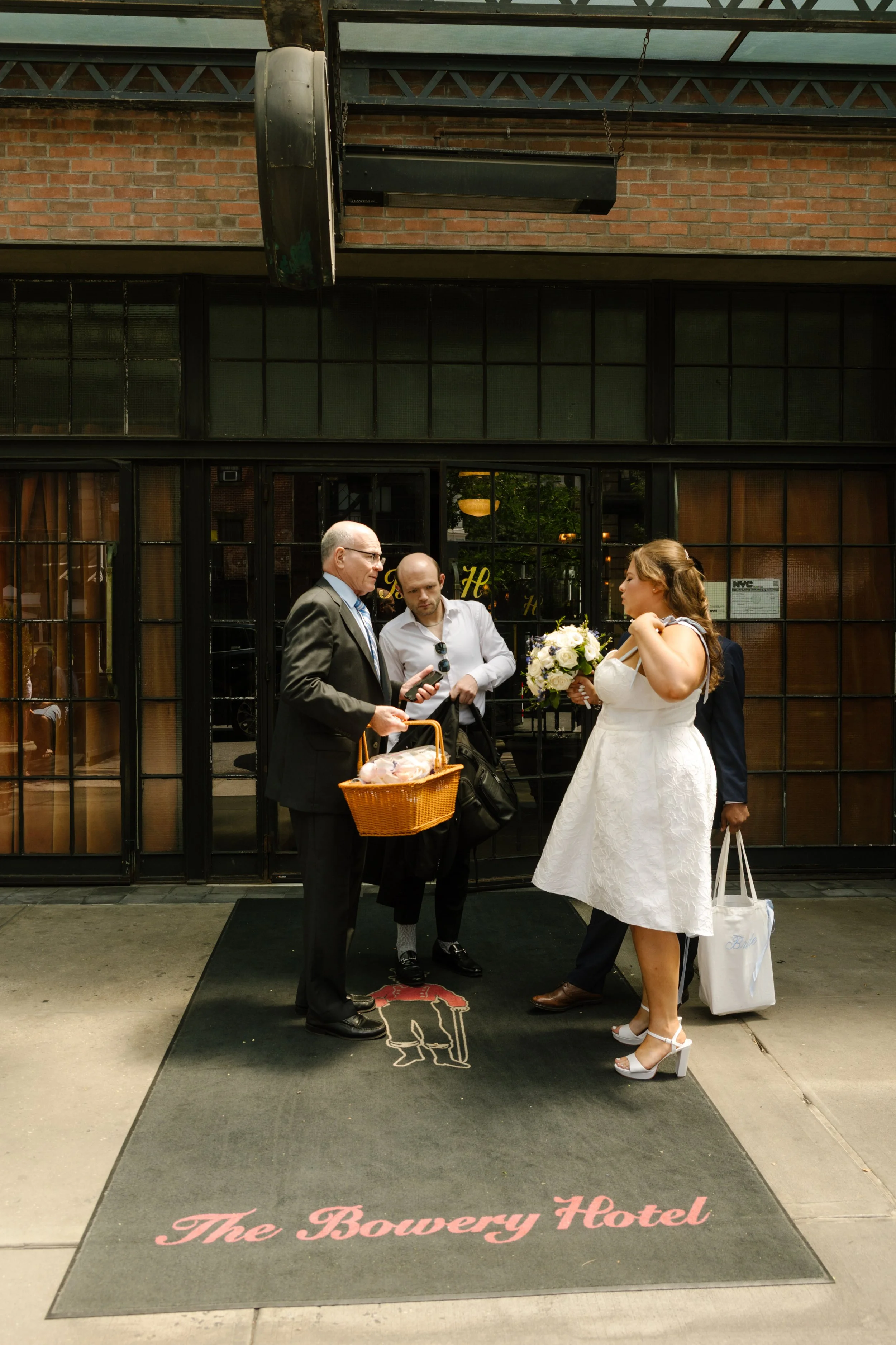Bride and family gather outside The Bowery Hotel before heading to the wedding ceremony, highlighting the charm of iconic NYC hotels.